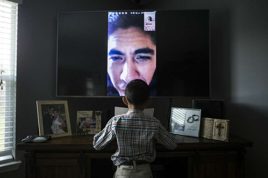 Jose Escobar, who lived in the U.S. for almost two decades, watches from El Salvador as his 7-year-old son opens kindergarten graduation gifts. The father of two and husband of an American citizen came to Houston with his mother as a teen but lost his legal status through a clerical error. He was deported under new federal guidelines. Photo: Marie D. De Jesús