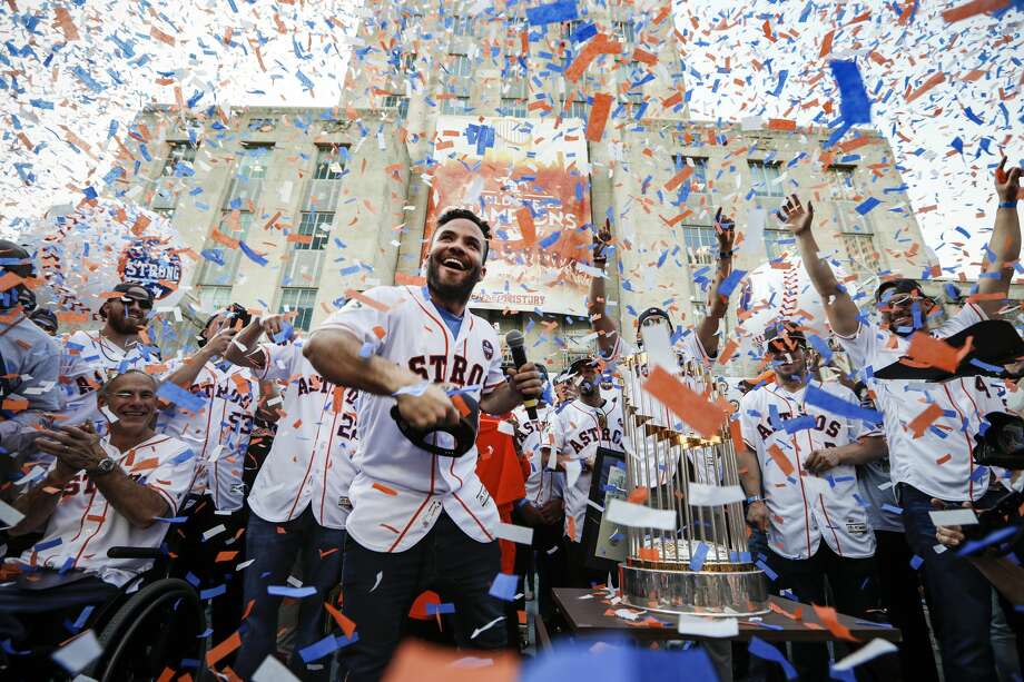 Star second baseman Jose Altuve joyfully tosses a World Series cap into the crowd in front of City Hall during the celebration honoring the Astros and their world championship. Confetti rained over the team  and Gov. Greg Abbott, appropriately attired in an Astros jersey  and for a moment obscured the trophy that eluded the organization since becoming a major league team in 1962. Photo: Brett Coomer