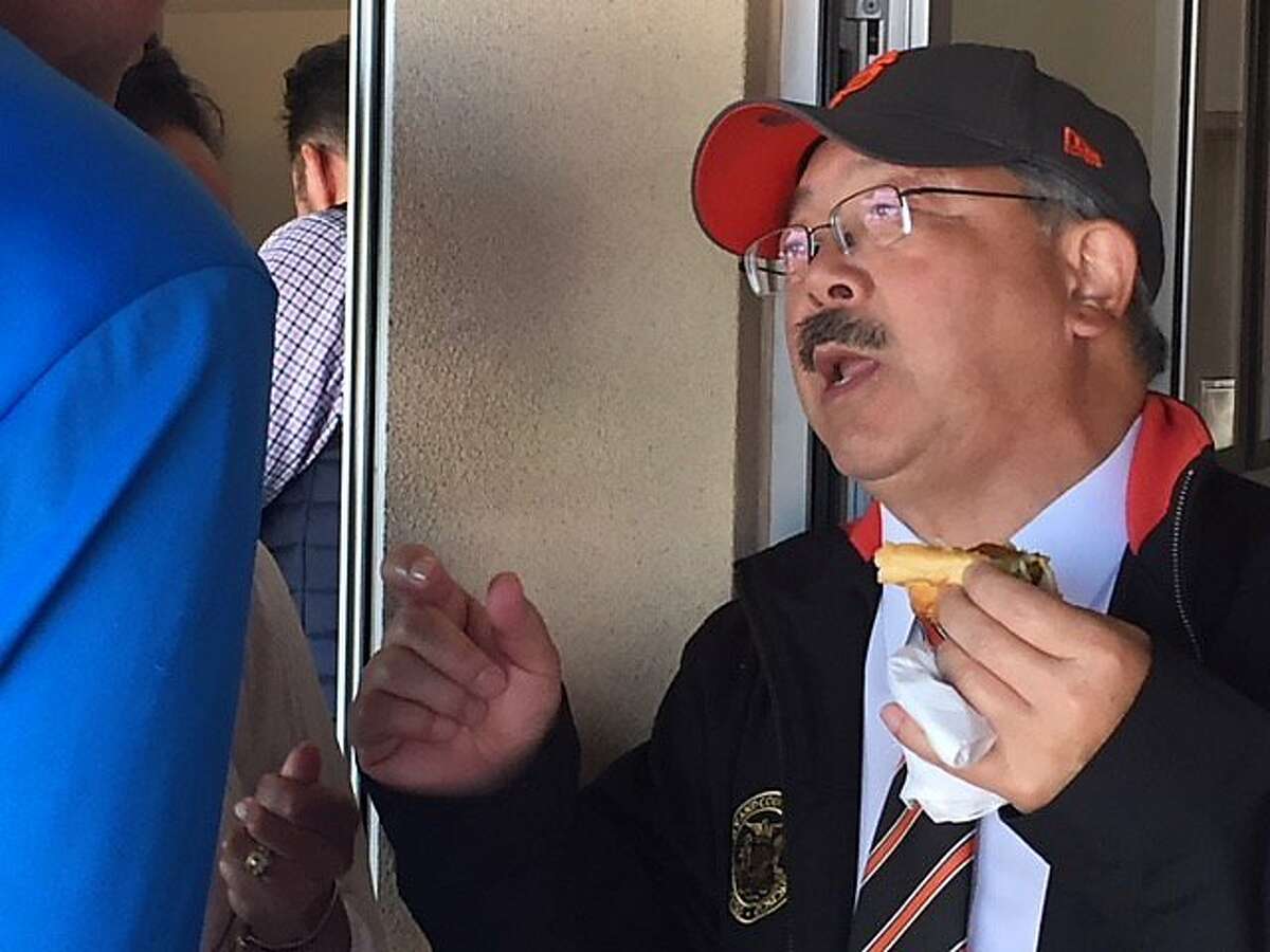 Mayor Ed Lee eats a hot dog on opening day, 2017