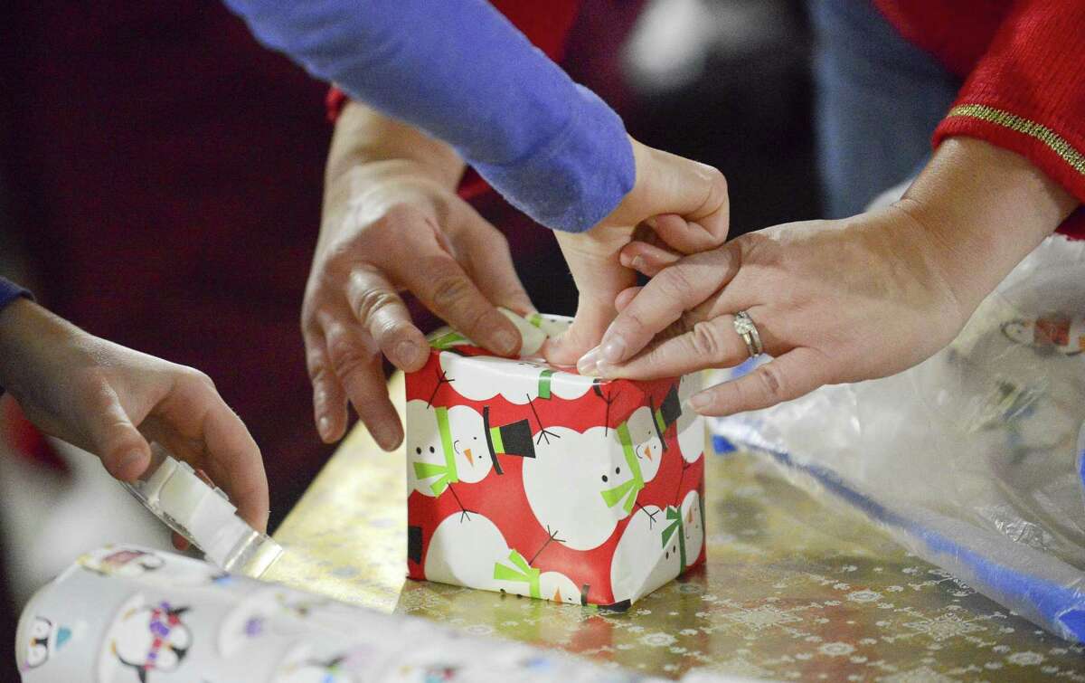 A brigade of volunteers wrap some 6,000 personalized holiday gifts for 3,000 children in Fairfield County at Inspirica in Stamford, Conn. on Dec. 9, 2017. The recipients of the gifts are kids impacted by poverty, AIDS and homelessness.