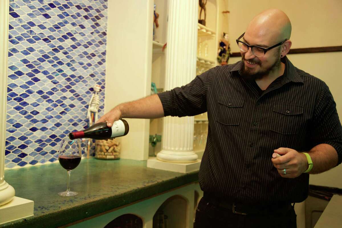 Rich Trevino pours a glass of wine at Pam’s Patio Kitchen.