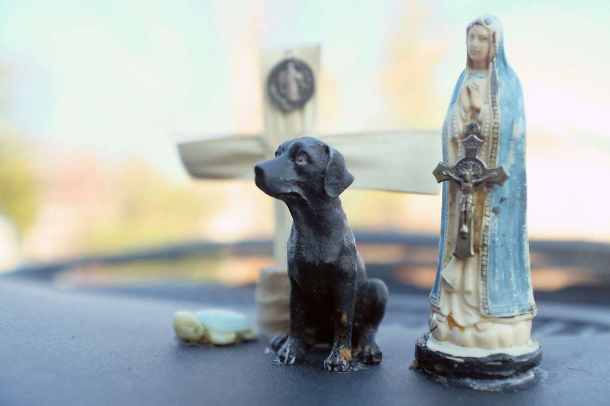 A cross and figurines of Saint Mary, a turtle and a black lab grace the dashboard of the van where Joe had been living with his dog, Bronson. "To ward off bad spirits," Joe said on Dec. 4, 2017. Having a pet can make finding a shelter more difficult, since many shelters do not accept pets for safety and allergy reasons. Bronson recently passed away, shortly before Joe found permanent supportive housing.