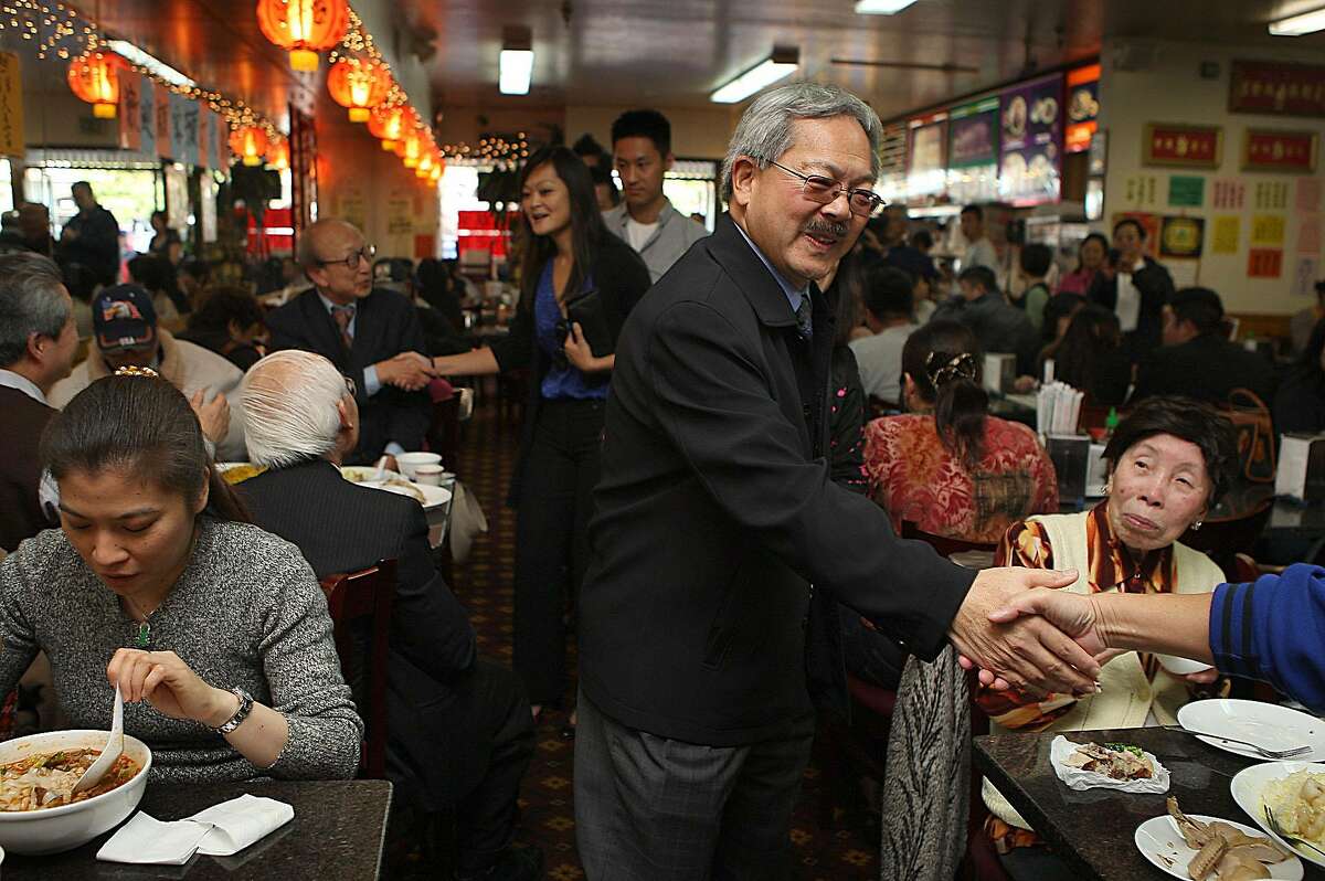 Mayor Ed Lee (middle) and supervisor Carmen Chu (back, middle) greeting the lunch crowd at Lam Hoa Thuan during a merchant walk on Irving St. in San Francisco, Calif., on Thursday, November 10, 2011.