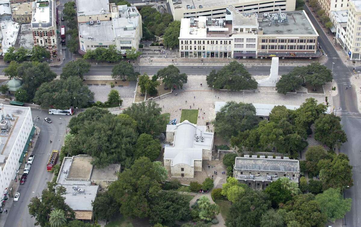 Alamo Plaza, with the Alamo bottom center of the image, is seen in a Thursday Oct. 8, 2015 aerial photo. Three buildings the Texas General Land Office recently agreed to buy are seen in the upper right side of the frame just behind the white marble cenotaph. A small portion of the Menger hotel can be seen on the lower left part of the image.