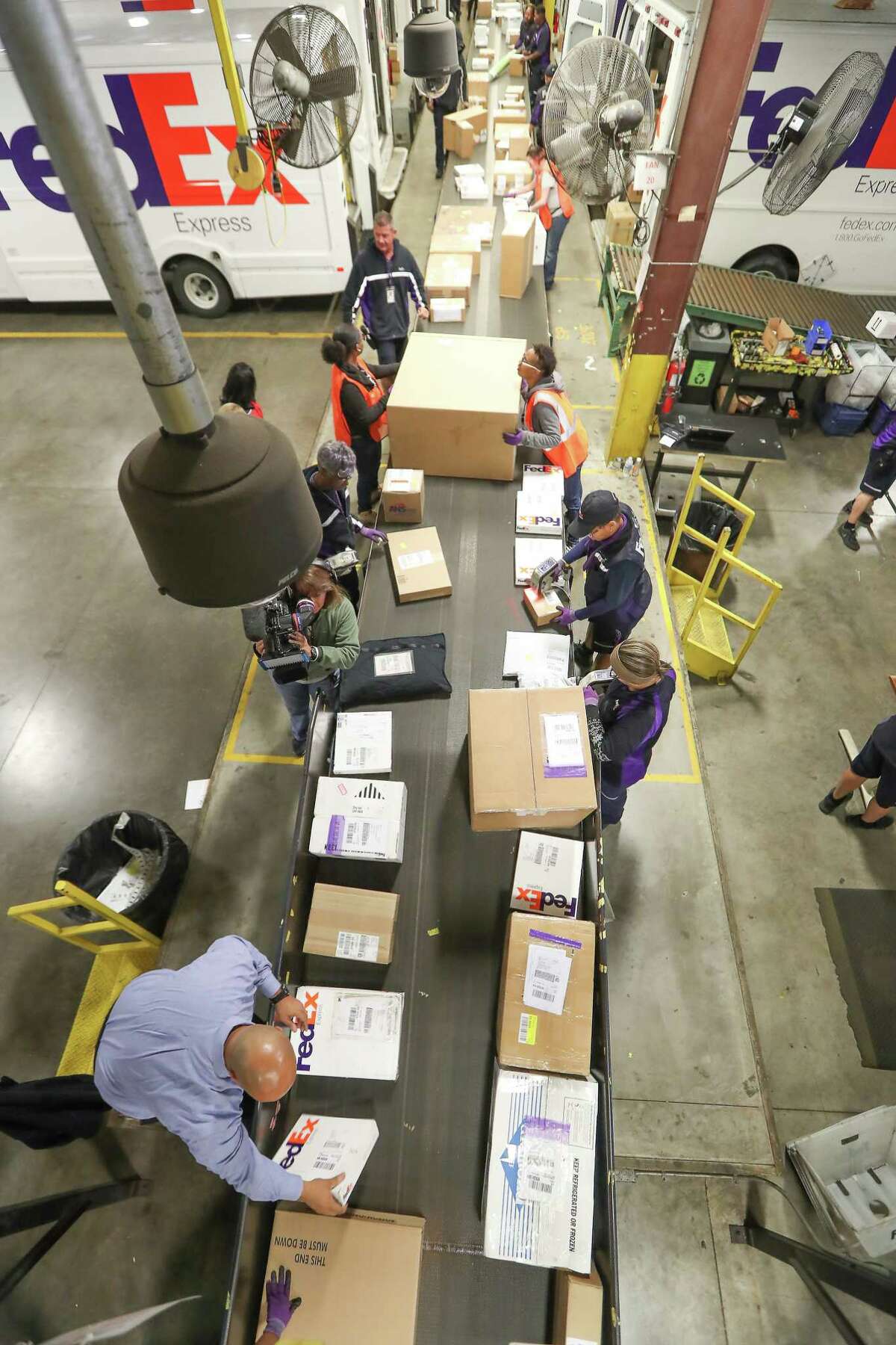 Packages flow down a conveyor belt in the FedEX's Holly Hall facility Tuesday, Dec. 12, 2017, in Houston. FedEx expects to ship 380 million to 400 million packages this holiday season. The Holly Hall facility in Houston is a critical part of the overall operation for the Houston area, and it's plugged into the company's global shipping network. ( Steve Gonzales / Houston Chronicle )
