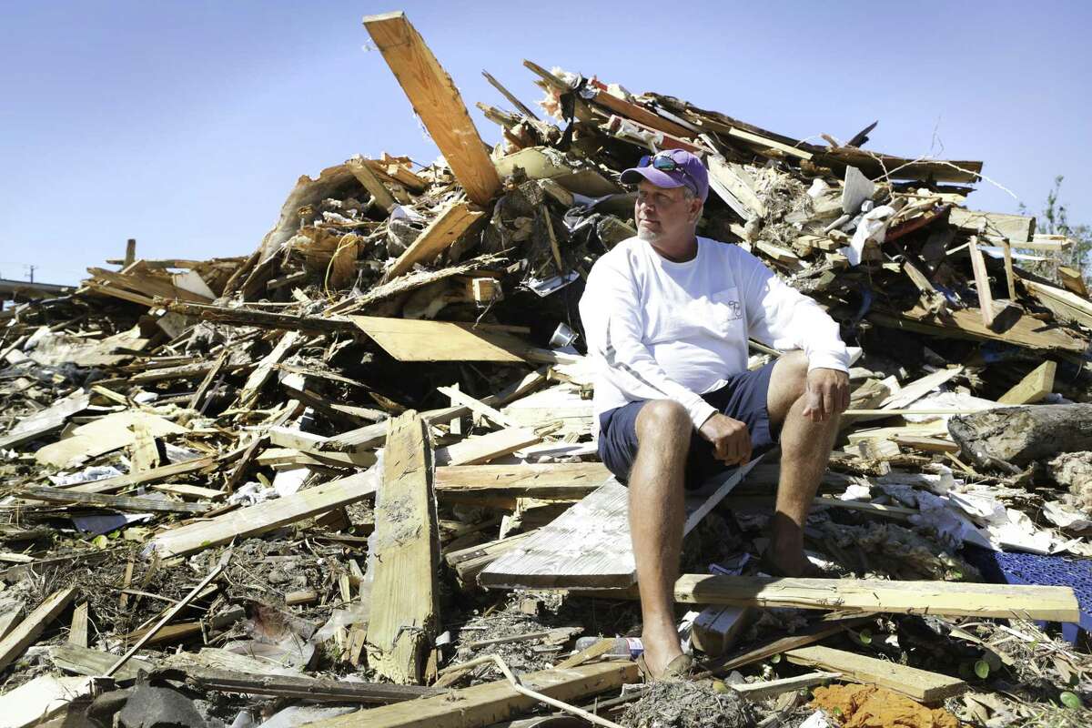 Gray Gant, 51, , sits on the rubble in 2017 that was his house before Hurricane Harvey hit Port Aransas. A report makes recommendation to prepare for the next disaster.