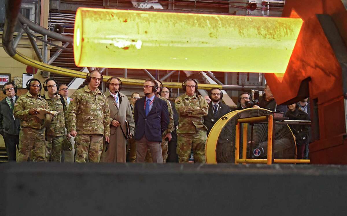Gustave (Gus) Perna, fifth from left, a United States Army four-star general who serves as Commander of the United States Army Materiel Command, watches as a gun barrel is transported after being taken out of a furnace in the rotary forge building as he visits the Watervliet Arsenal on Monday, Dec. 11, 2017 in Watervliet, N.Y. (Lori Van Buren / Times Union)