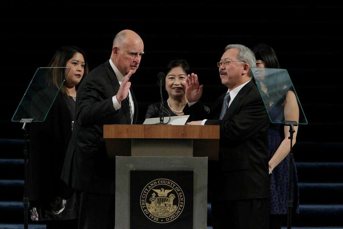 The Mayoral Oath of Office is administered to Mayor Ed Lee (front right) by Governor Jerry Brown (front left) in the rotunda as Tania Lee (back left to right), Anita Lee and Brianna Lee watch during the Inauguration of Mayor Ed Lee at City Hall on Friday, January 8, 2015 in San Francisco, Calif.
