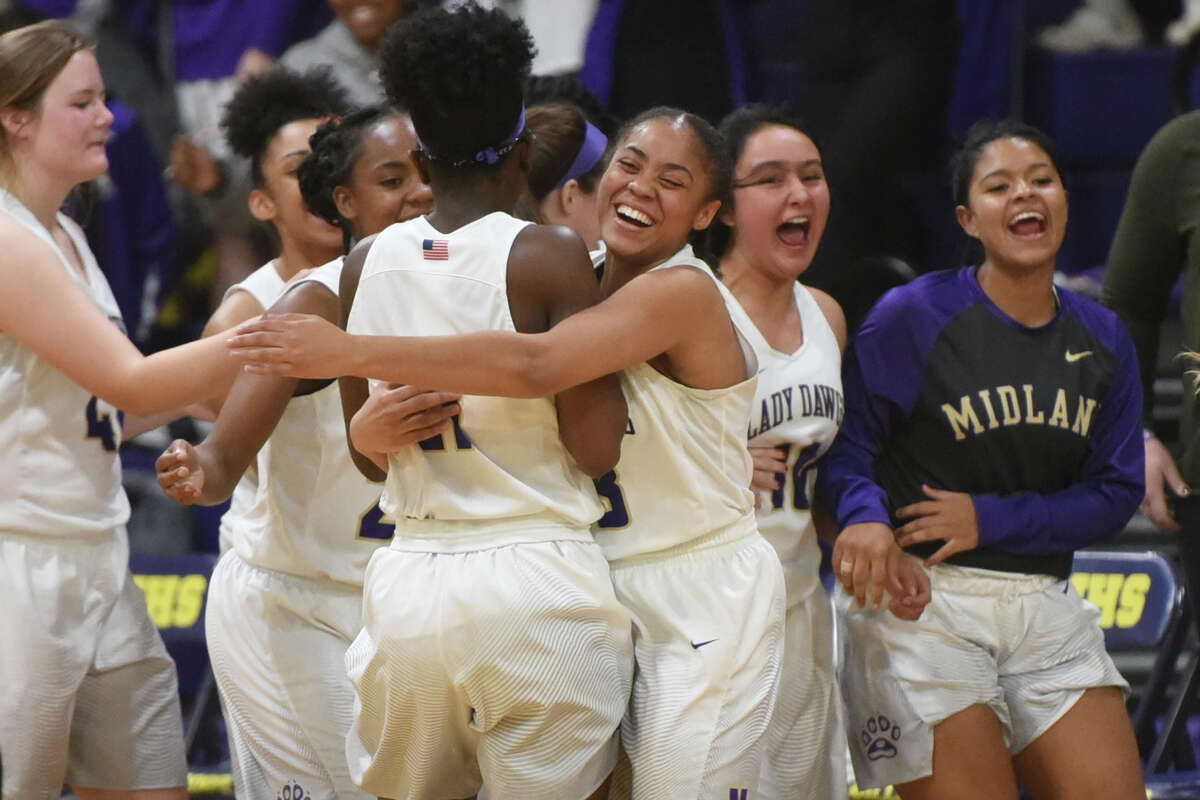 Midland High girls basketball players celebrate after scoring against Lubbock Monterey in overtime on Dec. 2, 2017, at Midland High. James Durbin/Reporter-Telegram