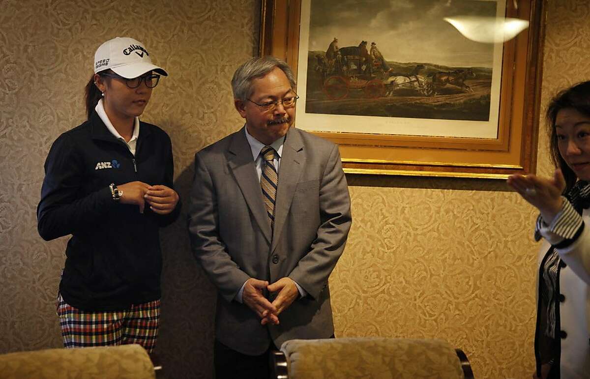 Lydia Ko (l to r) and Mayor Ed Lee stand together as Carol Su, IMG managing director Taiwan, organizes them and Yani Tseng (not shown) for a photo opportunity during media day for next month's Swinging Skirts LPGA Classic at Lake Merced Golf Club on Monday, March 10, 2014, in Daly City, Calif.
