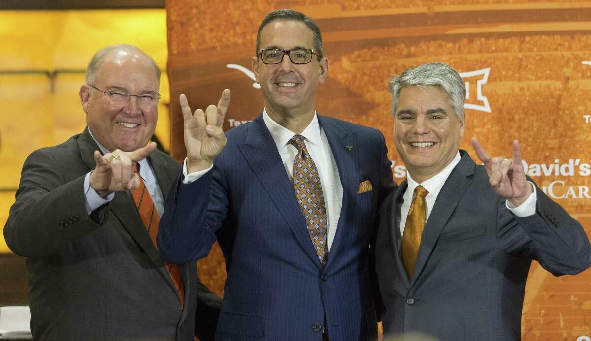 Interim Men's Athletics Director Mike Perrin, Chris Del Conte and Texas President Greg Fenves pose for photo as Del Conte is announced as the new vice president and athletics director at the University of Texas, Monday, Dec. 11, 2017. (Stephen Spillman / for American-Statesman)