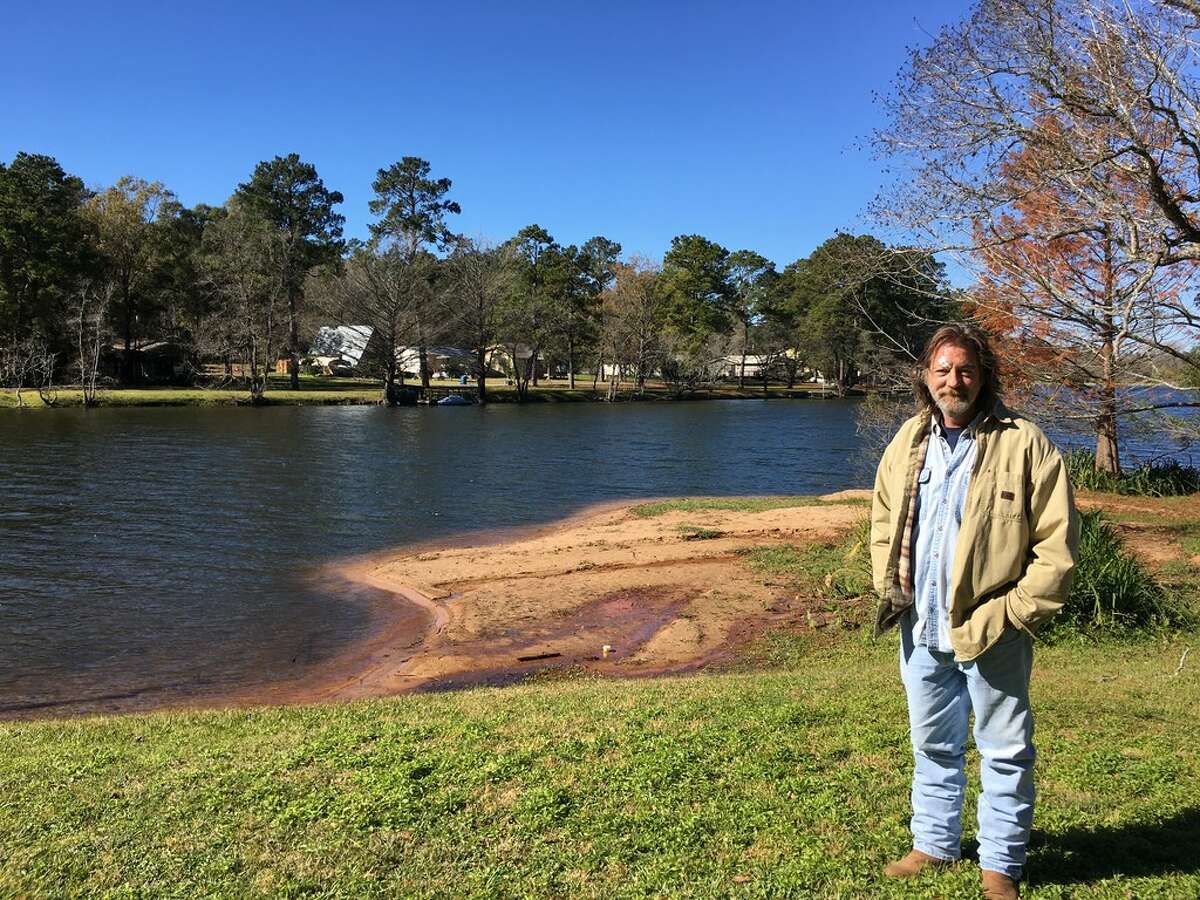 Troy Schroeder stands at the edge of Pine Lake about 10 miles west of Conroe in December, 2017. Schroeder and his neighbors oppose the city's plan to annex their development.