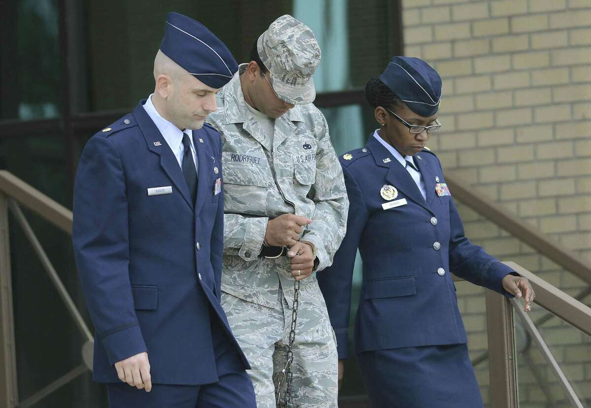 Air Force Tech Sergeant Jaime Rodriguez, middle, exits the court at Lackland Air Force Base where he was sentenced for sex crimes on Friday, June 14, 2013.