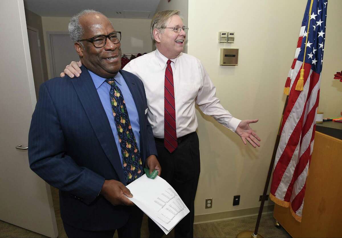 Dudley Williams, Mill River Collaborative director, left, is surprised by Stamford Mayor David Martin and many of his co-workers and friends after learning he had been named as Stamford's 2017 Citizen of the Year. Several dozen gathered for a surprise ceremony in the Mayor's office at the Government Center in Stamford, Conn. on Dec. 13, 2017.