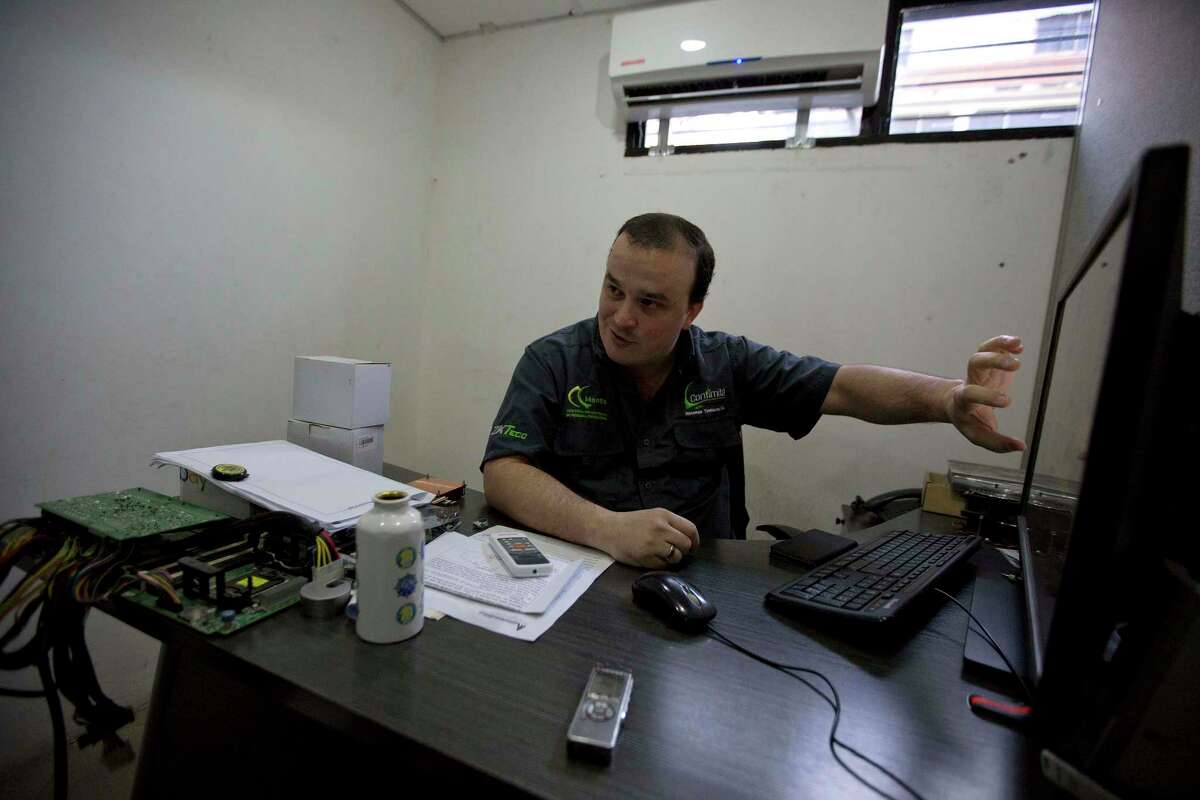 John Villar speaks during an interview at his office in Caracas, Venezuela, Tuesday, Dec. 12, 2017. In the last month, John Villar has bought two plane tickets to Colombia, purchased his wifeÂ?’s medication and paid the employees of his startup business in Venezuela - all in bitcoin. (AP Photo/Fernando Llano)
