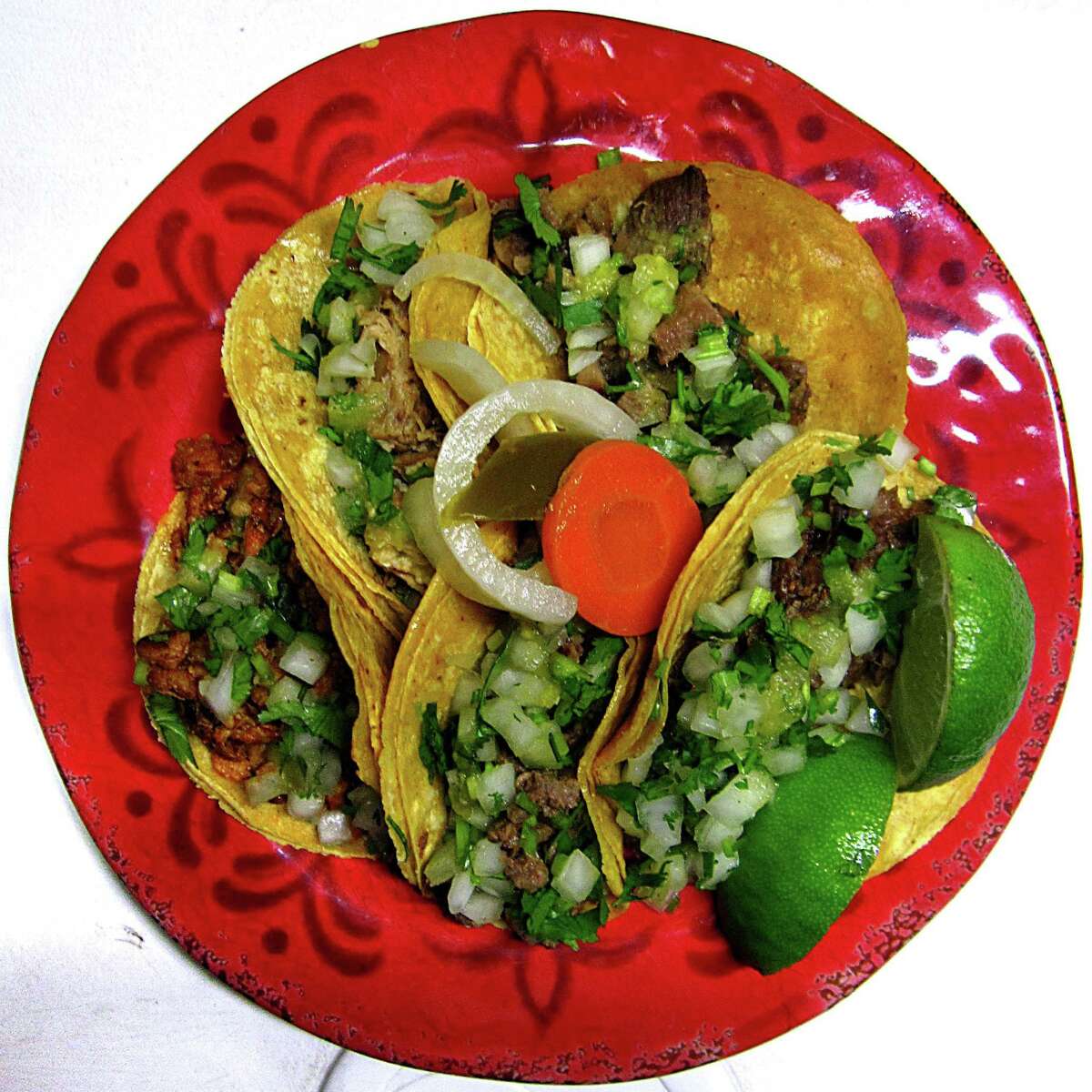 Tacos of the Week: $1 street tacos with asada, lengua, carnitas, pastor and cabeza on doubled-up corn tortillas with onions, cilantro, limes and escabeche from Tacos La Salsita truck.