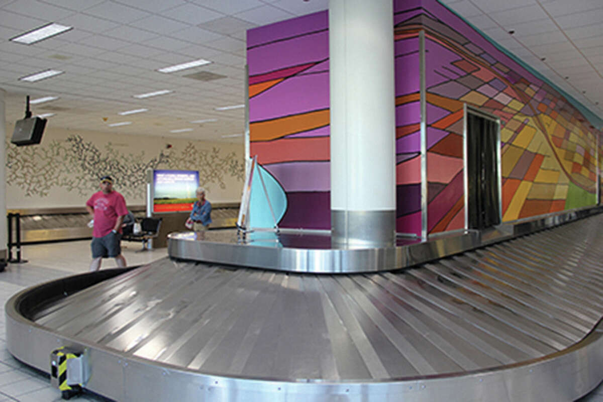 Artists Megan Singleton and Ellie Balk have painted murals on the baggage claim carousels in Terminal 2 at St. Louis Lambert International Airport.