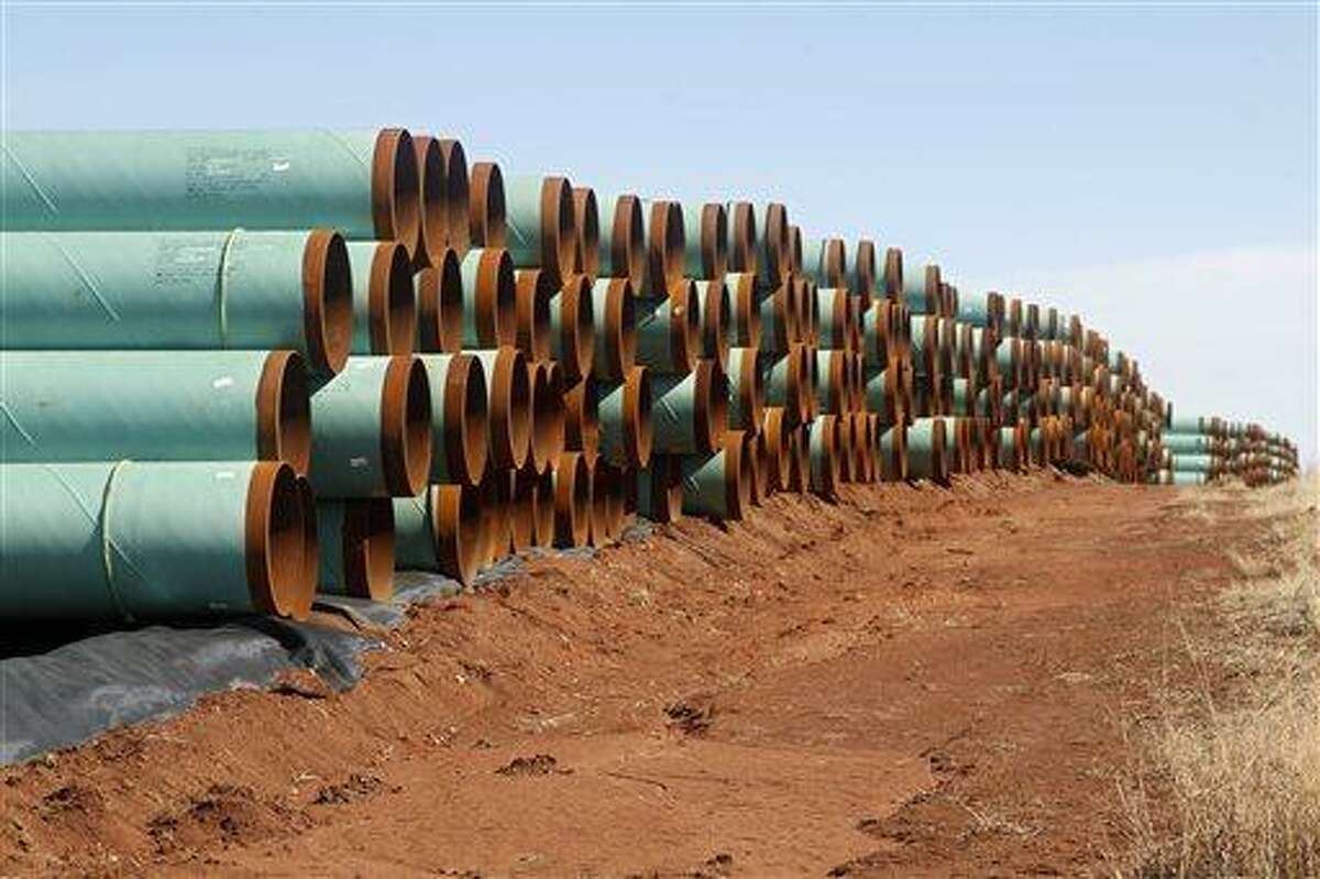 In this Feb. 1, 2012 photo, miles of pipe for the Canada-to-Texas Keystone XL pipeline are stacked in a field near Ripley, Okla. Pipeline companies are fighting to maintain tax breaks that allow them to deduct the borrowing costs on construction projects that take years to permit and build.