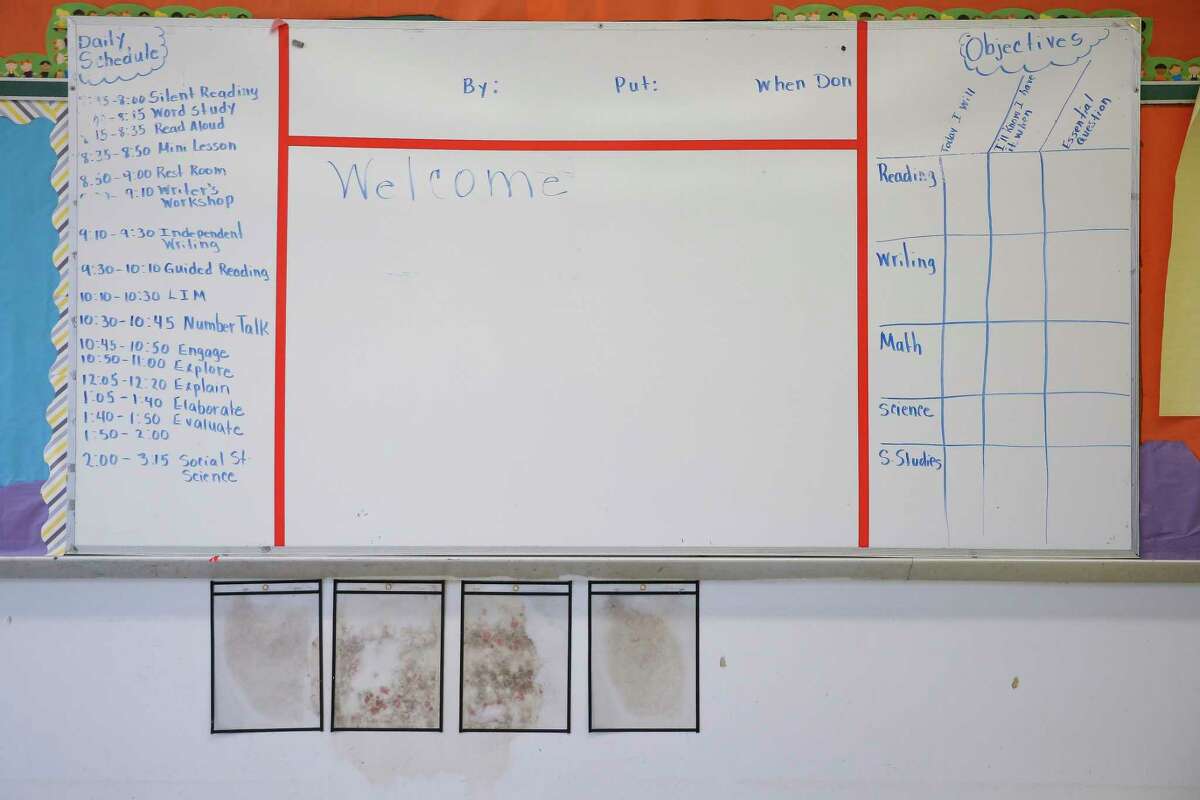 Mold grows under a whiteboard in a classroom at Mitchell Elementary Thursday, Dec. 14, 2017 in Houston. The school was flooded with about two feet of water during Hurricane Harvey.