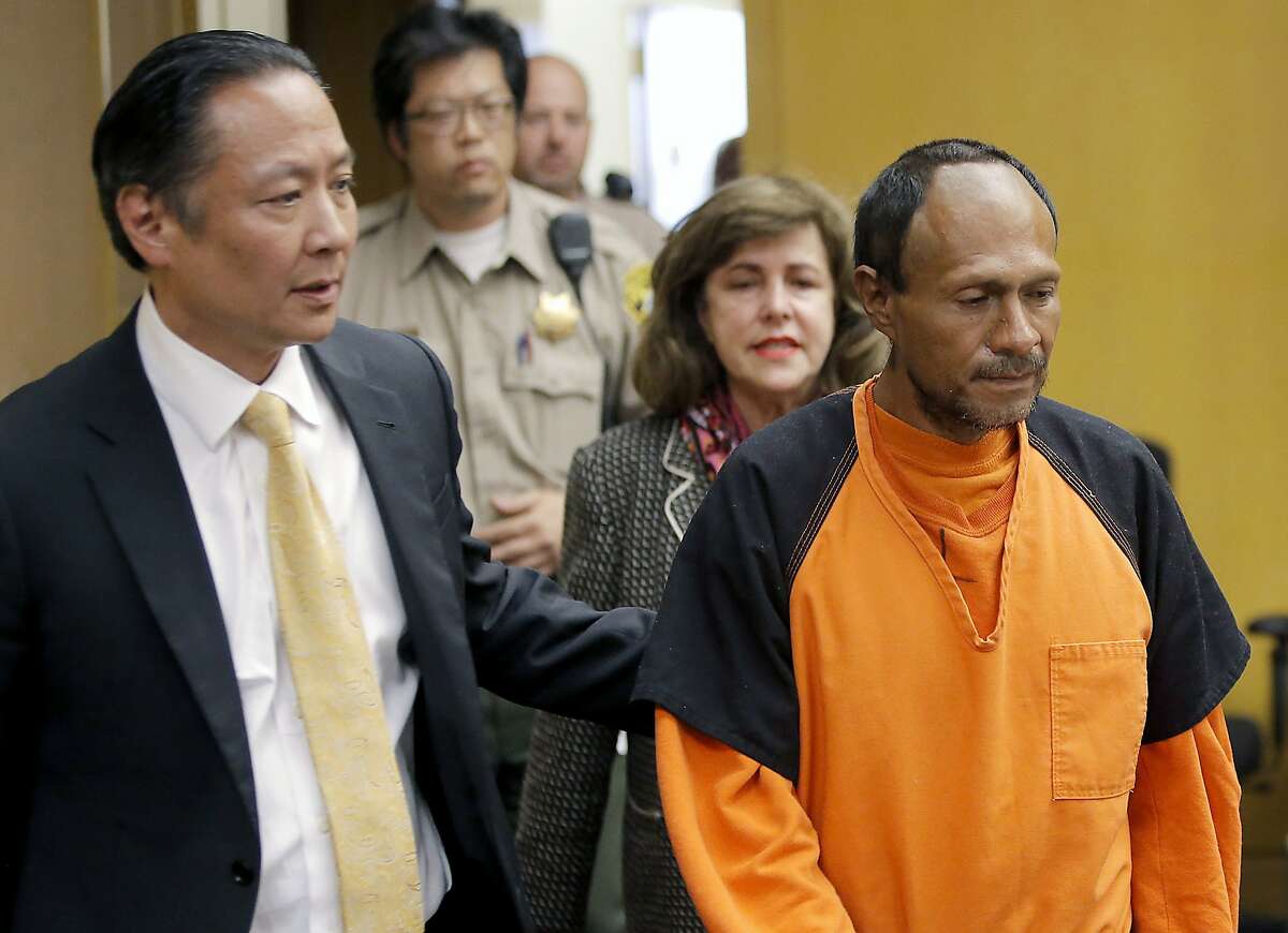 FILE - In this July 7, 2015 file photo, Jose Ines Garcia Zarate, right, is led into the courtroom by San Francisco Public Defender Jeff Adachi, left, and Assistant District Attorney Diana Garciaor, center, for his arraignment at the Hall of Justice in San Francisco. San Francisco District Attorney George Gascon, Tuesday, Dec. 5, 2017, defended the handling of the murder trial that ended with the acquittal of Garcia Zarate, whose arrest set off a fierce national debate on immigration. (Michael Macor/San Francisco Chronicle via AP, Pool, File)