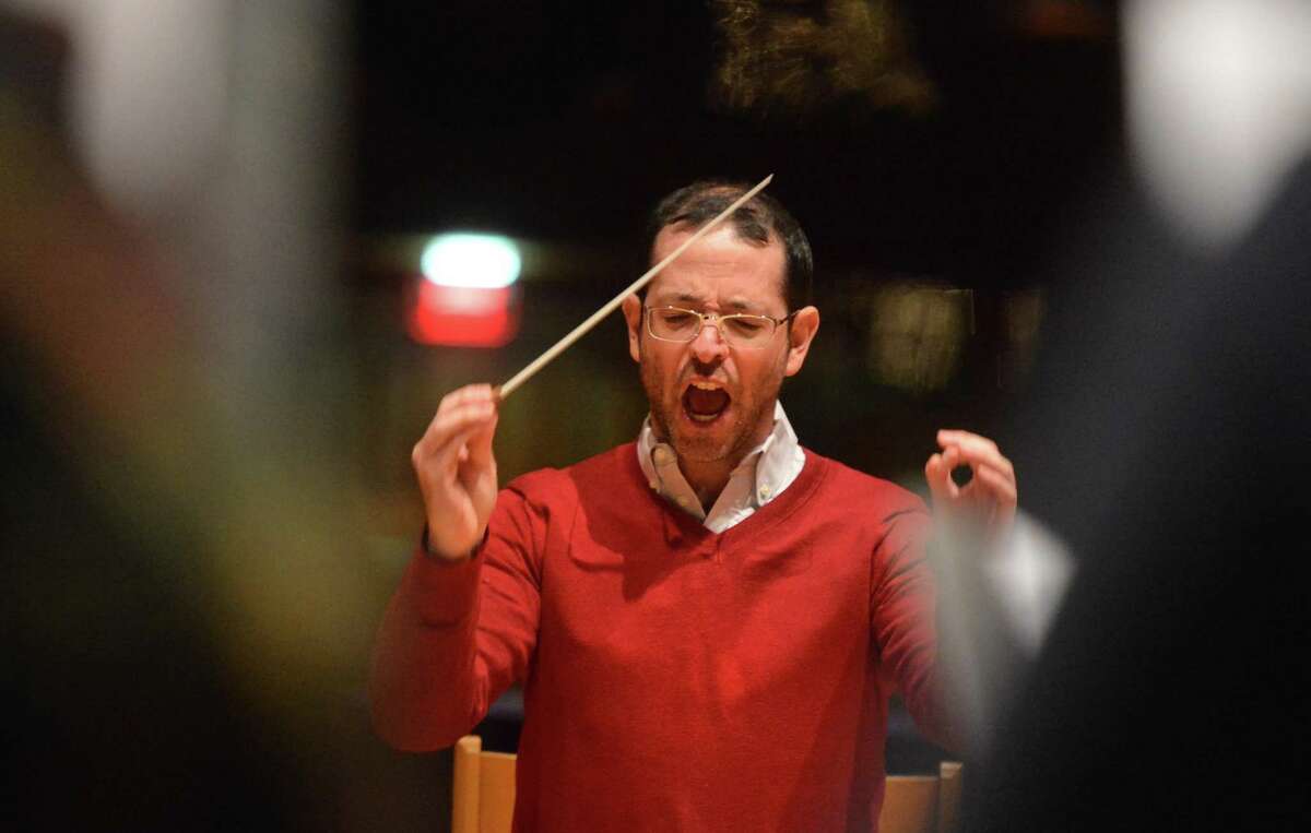 The Norwalk Symphony Orchestra Music Director Jonathan Yates goes over a piece by Bach with the Mendelssohn Choir of Connecticut during rehearsal at St. Lukes's Church in Westport Conn. on Tuesday December 12, 2017 for their upcoming concert Joys of the Season: Bach to Pops at The Norwalk Concert Hall