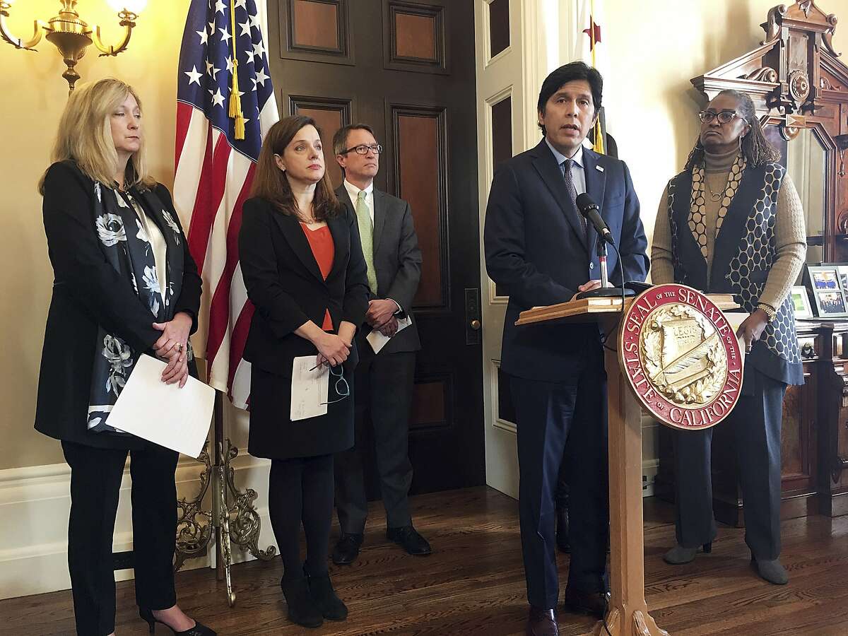 California Senate President Pro Tem Kevin de Leon, D-Los Angeles, at podium, speaks to reporters during a news conference in his office at the state Capitol in Sacramento, Calif., Thursday, Dec. 14, 2017. De Leon ramped up pressure on his fellow Democrat, Sen. Tony Mendoza of Artesia, to take a leave of absence until an investigation of his alleged sexual misconduct ends. De Leon was joined by attorneys and victims' advocates who will conduct investigations into allegations of sexual misconduct. (AP Photo/Jonathan J. Cooper)