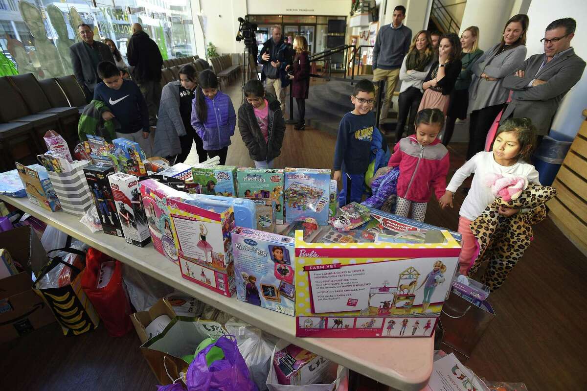 Nine children from the Boys and Girls Club of Stamford checks out some of the 150 toys collected by NBCUniversal employees, as part of the company's annual Holiday Toy Drive, at the Stamford Media Studio in Stamford, Conn. on Dec. 14, 2017. Employees participating in the toy drive received a personalized "wish card" from a child who participates in the clubs after school program that specified which toy he or she would like to receive.