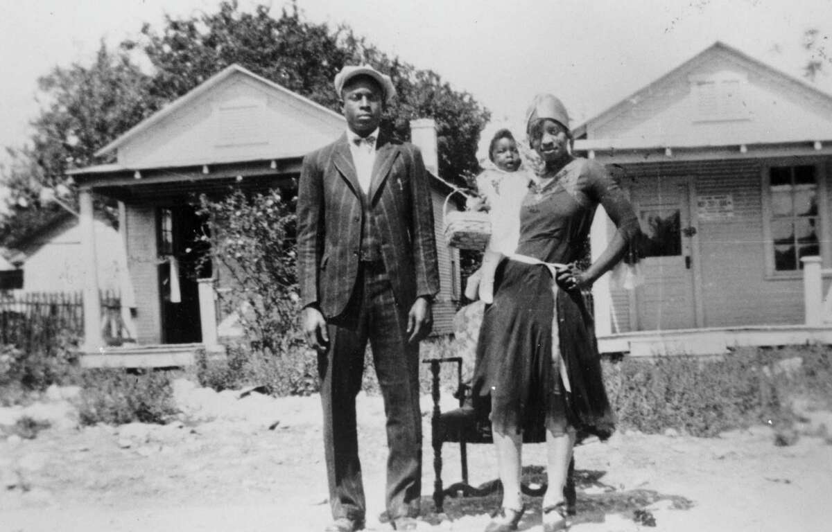 Loil Ellison and wife, Estella Ellison, and daughter Estella Mae Ellison stand in front of their house at 520 Callaghan Ave., in early the 1930s. In the background are shotgun-style houses, across the street at 519 (left) and 521 Callaghan Ave., in a neighborhood demolished to make way for the Victoria Courts public housing project.