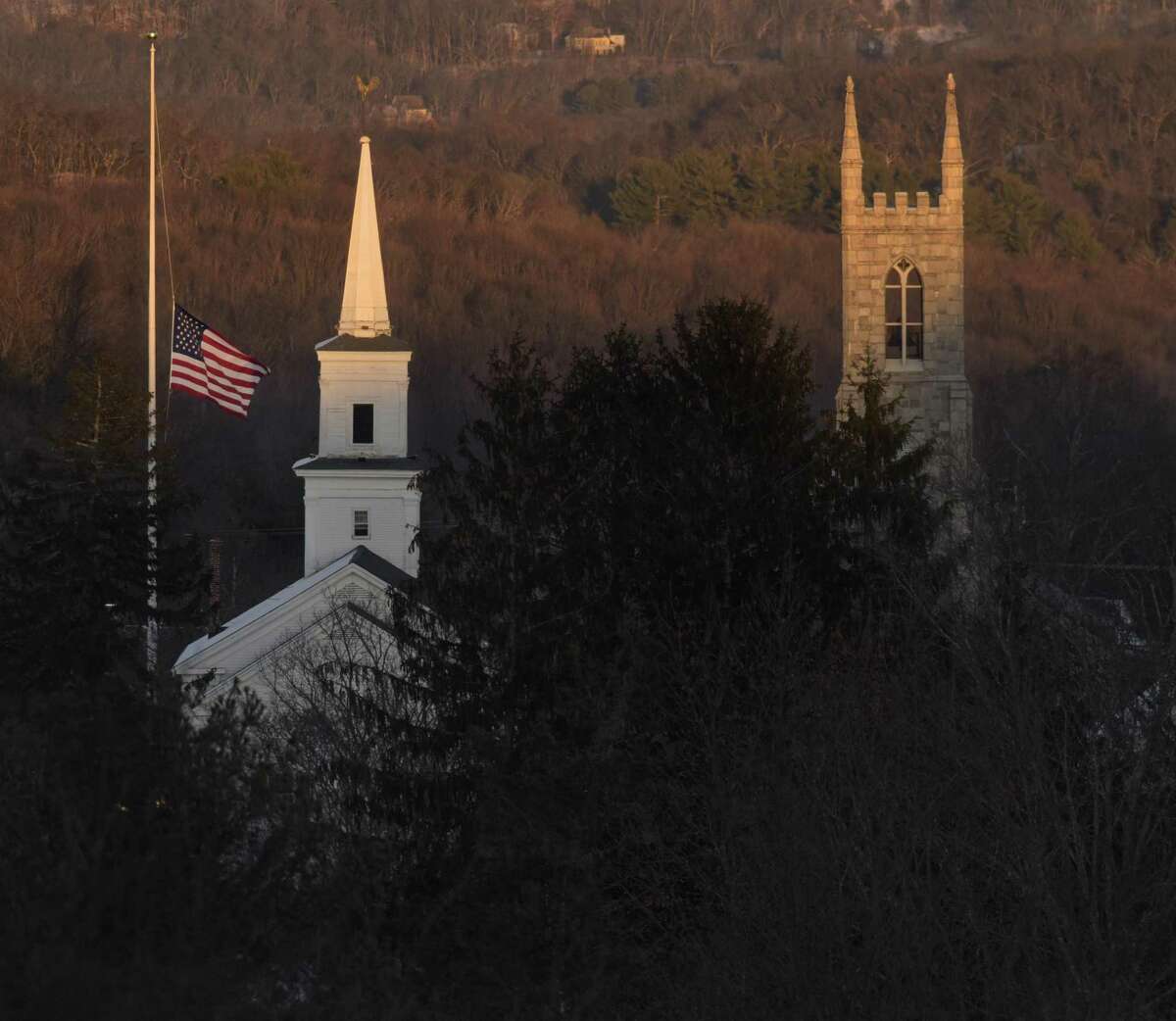 The flag on the Newtown flag pole flies at half-staff, like all the others across the state Thursday, in memory of the victims of the Sandy Hook Elementary School shooting.