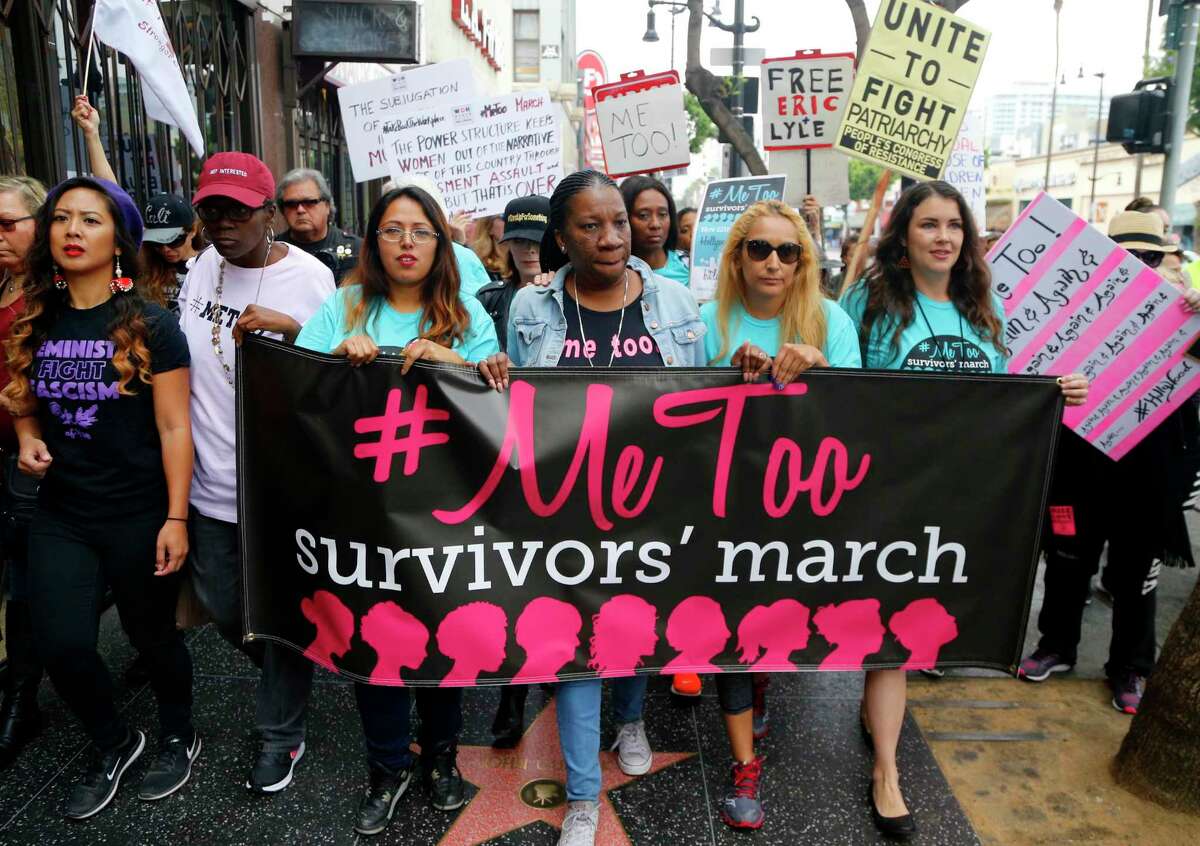 Tarana Burke, center, marches against sexual assault and harassment at the #MeToo March in the Hollywood section of Los Angeles on Sunday, Nov. 12, 2017. (AP Photo/Damian Dovarganes)