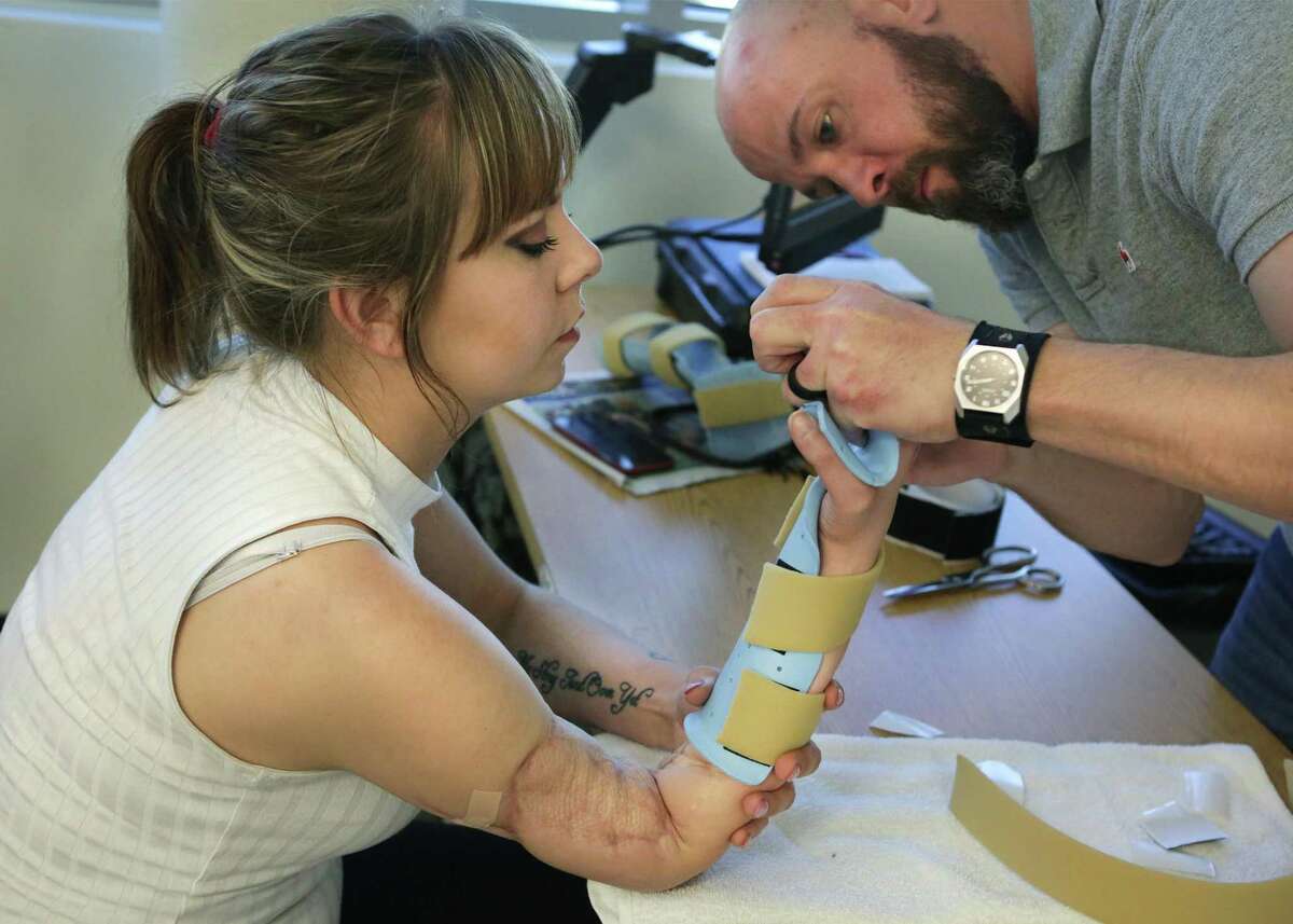 Kelsey Ward works with her occupational therapist, Christopher Ebner at the Center for the Intrepid at Joint Base San Antonio Ft. Sam Houston on Friday, Feb. 17, 2017.