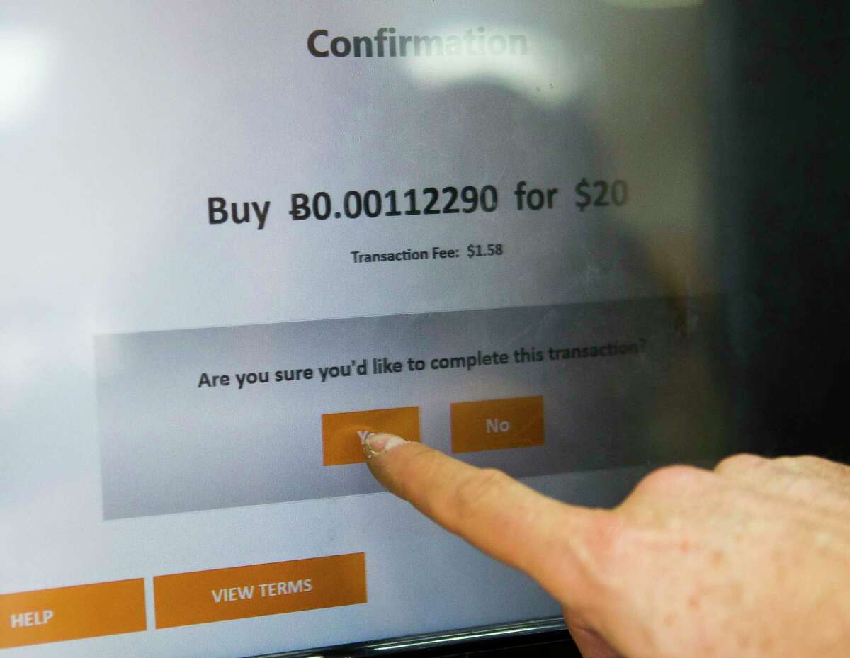 Sheldon Weisfeld purchases $20 worth of Bitcoin from one of the CoinVault ATM machines he operates in the Houston area, this one at Smartphone Repair on Harwin Drive, Wednesday, Dec. 13, 2017, in Houston. Weisfeld operates three ATMs in the area that allow users to buy and sell Bitcoin. ( Mark Mulligan / Houston Chronicle )