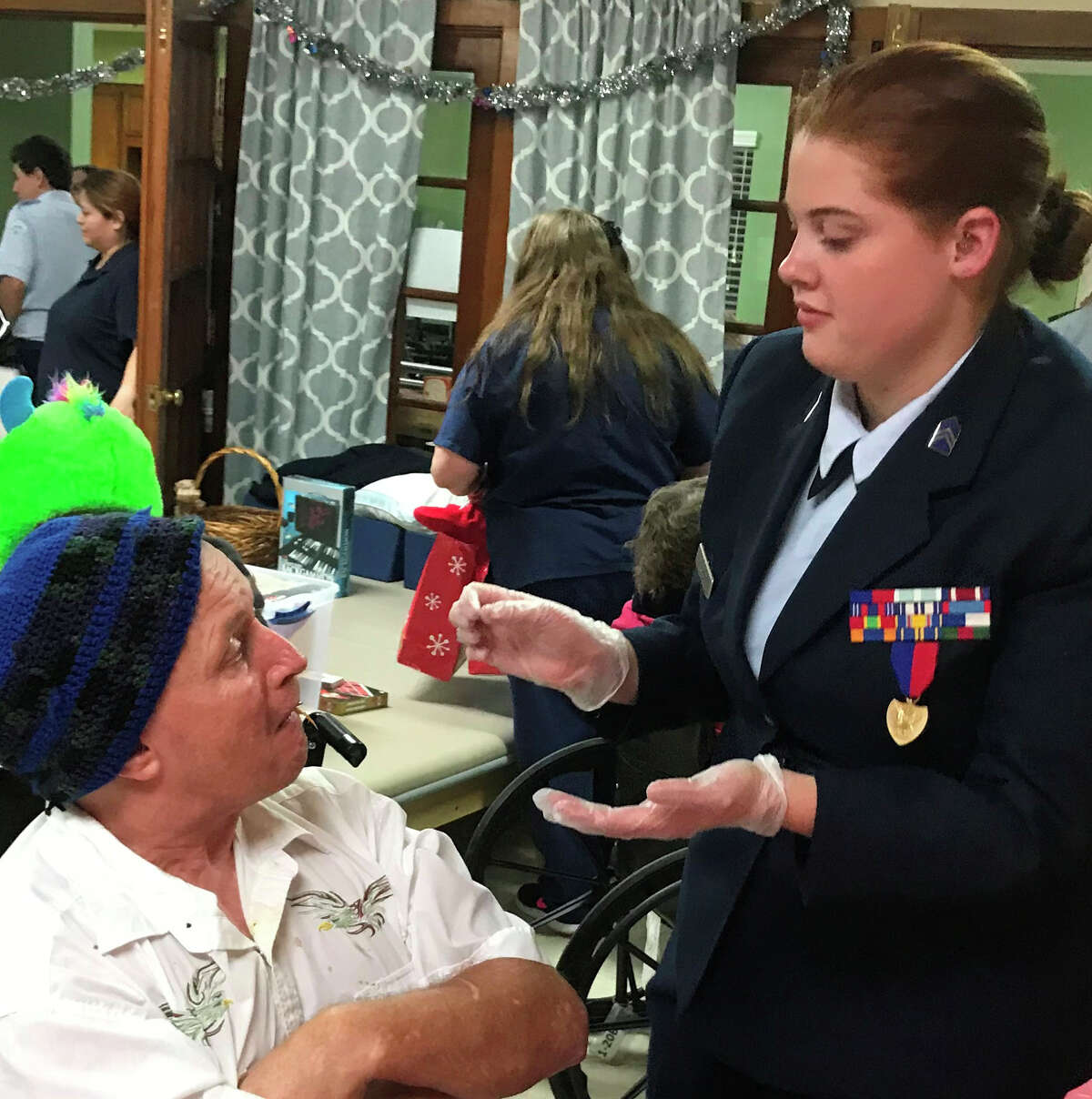 A Splendora Air Force JROTC cadets serves food to a resident ofÂ Pine Shadow Retreat Assisted Living Facility in Porter.