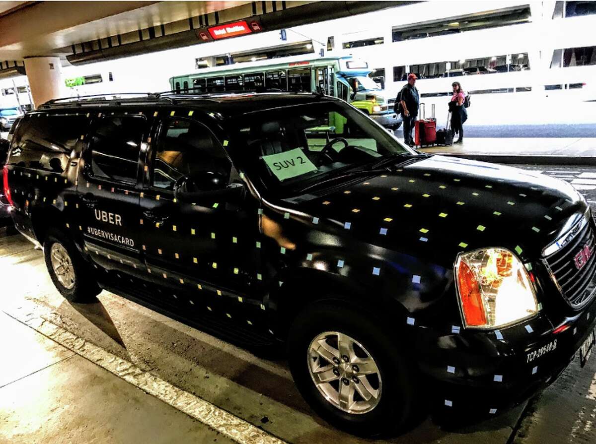 SFO is moving some high-end Uber rides back to the curbside in a test. Pictured: a specially wrapped Uber Black SUV