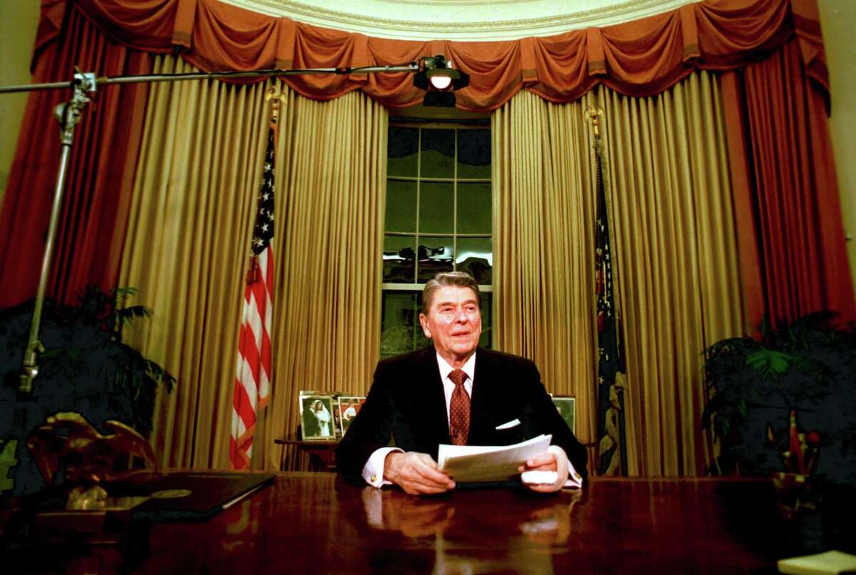 President Ronald Reagan is seen shortly after he delivered his farewell address to the nation at the Oval Office in the White House, Washington, on January 12, 1989. The situation has changed dramatically from the time Reagan signed tax cuts in the 1980s to the current economy.