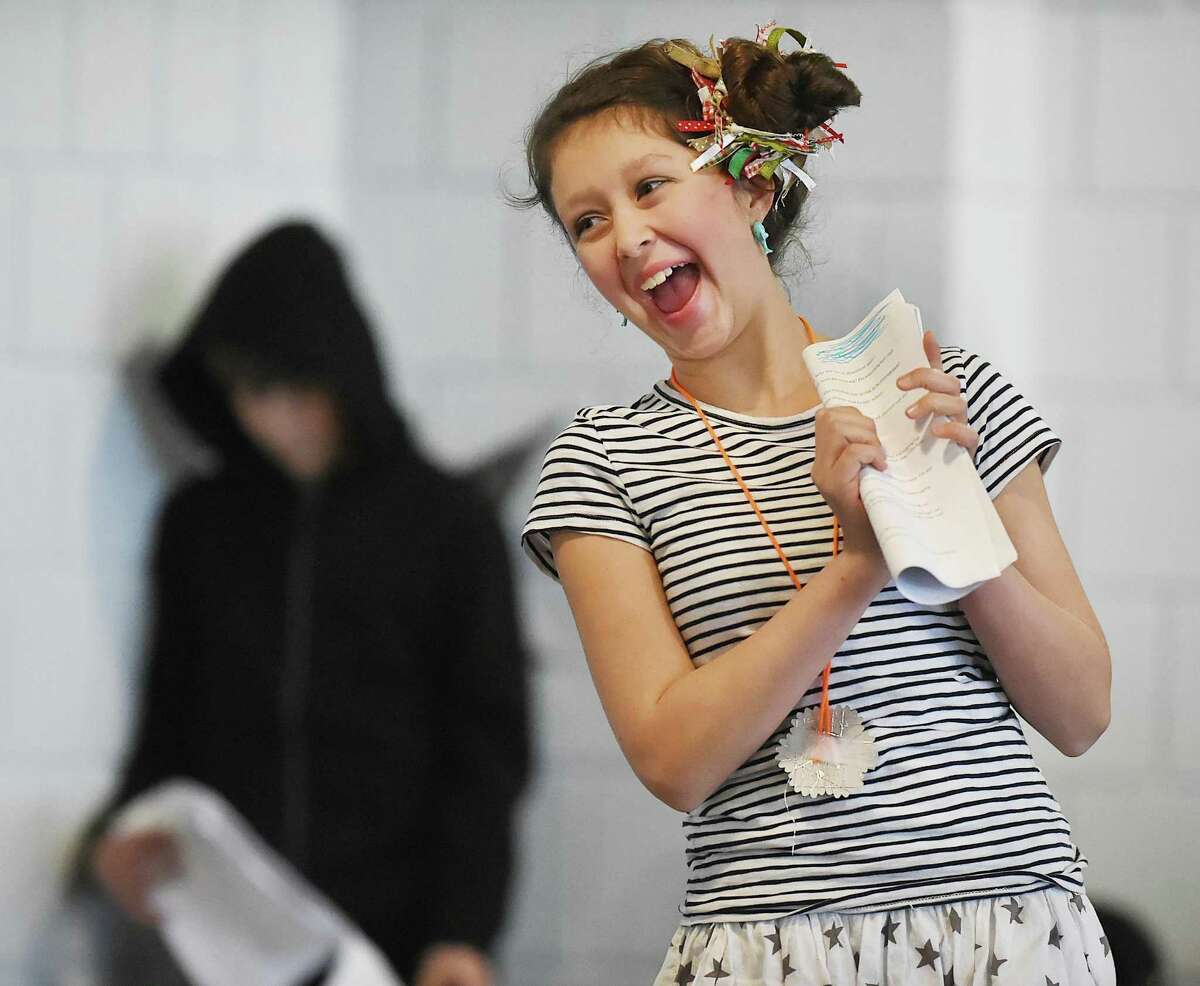 Adelaide Morrissey as Cella, performs in "Nightmare on Evil Street" at the Long Wharf Theatre Stage II, Friday, Dec. 15, 2017, in New Haven. Adelaide, a student in Long Wharf Theatre's annual drama class for the CT Experiential Learning Center (CELC) Middle School of Branford and homeschooled students and her classmates, age 9-14, participated in a nine-week course collaborating on all aspects of the play including performance, direction and design. In the background is Lorenzo Dalton as the unamed character.