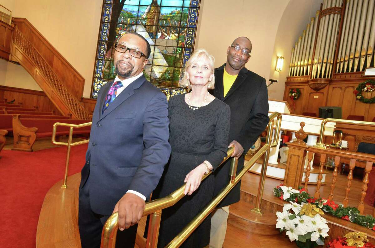 The Rev. DeWitt Stevens, Operations Manager Joleen Green and Rev. Michael Rumble stand on the stairs to the new raised pulpit at the Macedonia Church on Thursday December 14, 2017 in Norwalk Conn. The congregation purchased the 121-year-old building formerly First United Methodist Church on West Ave. in May of 2014, and have made extensive repairs and upgrades