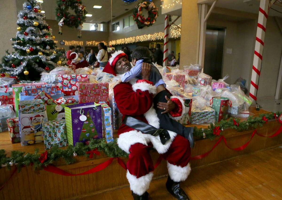 Santa Claus greets Mikel (cq) Cruchelow,4, Friday December 15, 2017 at a Christmas party held at Our Lady of the Lake University for the children of participants of Bexar County's Family Drug Court and Early Intervention Program. About 150 kids were treated to pizza and Christmas gifts at the event. Cruchelow was there with his father Mikel Cruchelow (same name) and his mother Linda Guzman and his sister Xena Cruchelow,3.