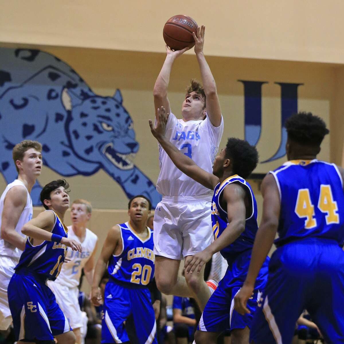 Johnson's Zach Keller (center) scored 20 points each in wins vs. Roosevelt and Churchill to help the Jaguars win the District 27-6A championship.
