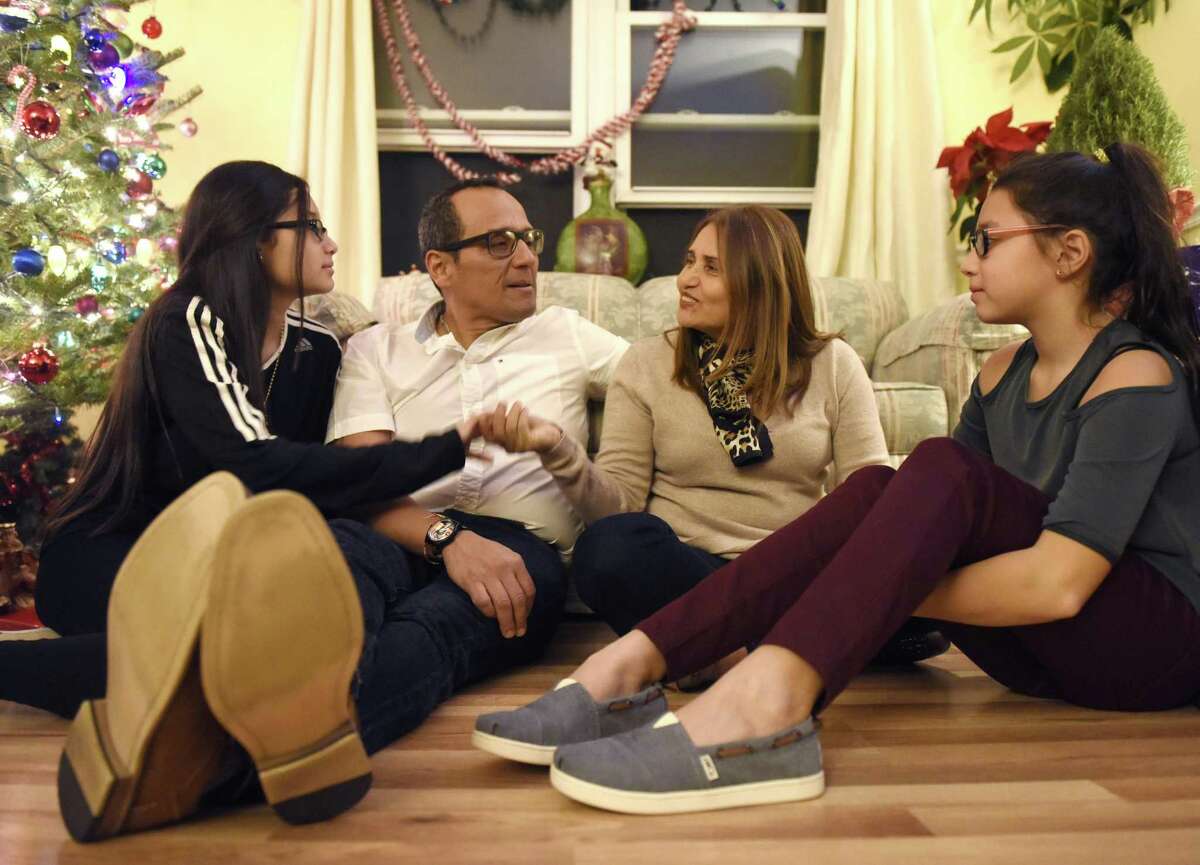 Miriam Martinez and her husband, Luis Raphael Benavides, chat with their children, Brianna, left, 12, and Allison, 10, at their home in Stamford Monday, Miriam Martinez is an undocumented immigrant who almost faced deportation to Guatemala last month. Brianna has type 1 juvenile diabetes that requires around-the-clock monitoring.