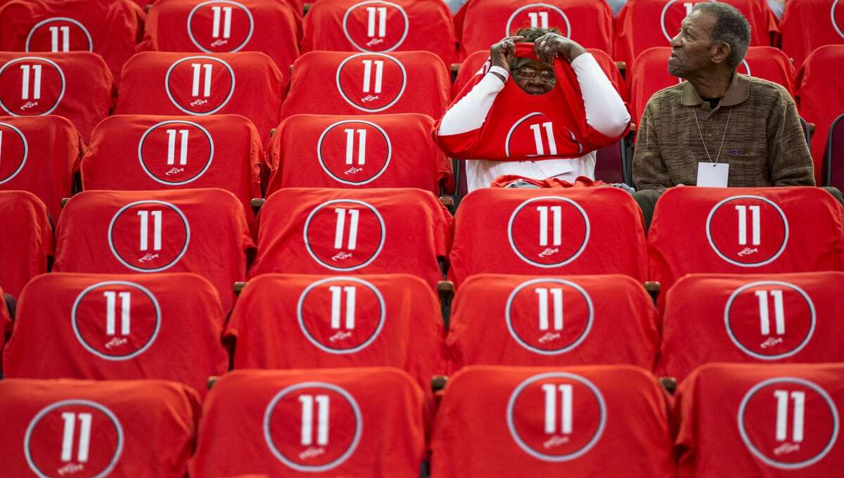 Rosie Beverley, left, and Elroy Beverley, Jr., Houston Rockets guard Patrick Beverley's great-grandparents, sit surrounded by t-shirts honoring center Yao Ming before an NBA basketball game against the Chicago Bulls at Toyota Center on Friday, Feb. 3, 2017, in Houston. The Rockets are retiring Yao's jersey number 11 during a halftime ceremony.