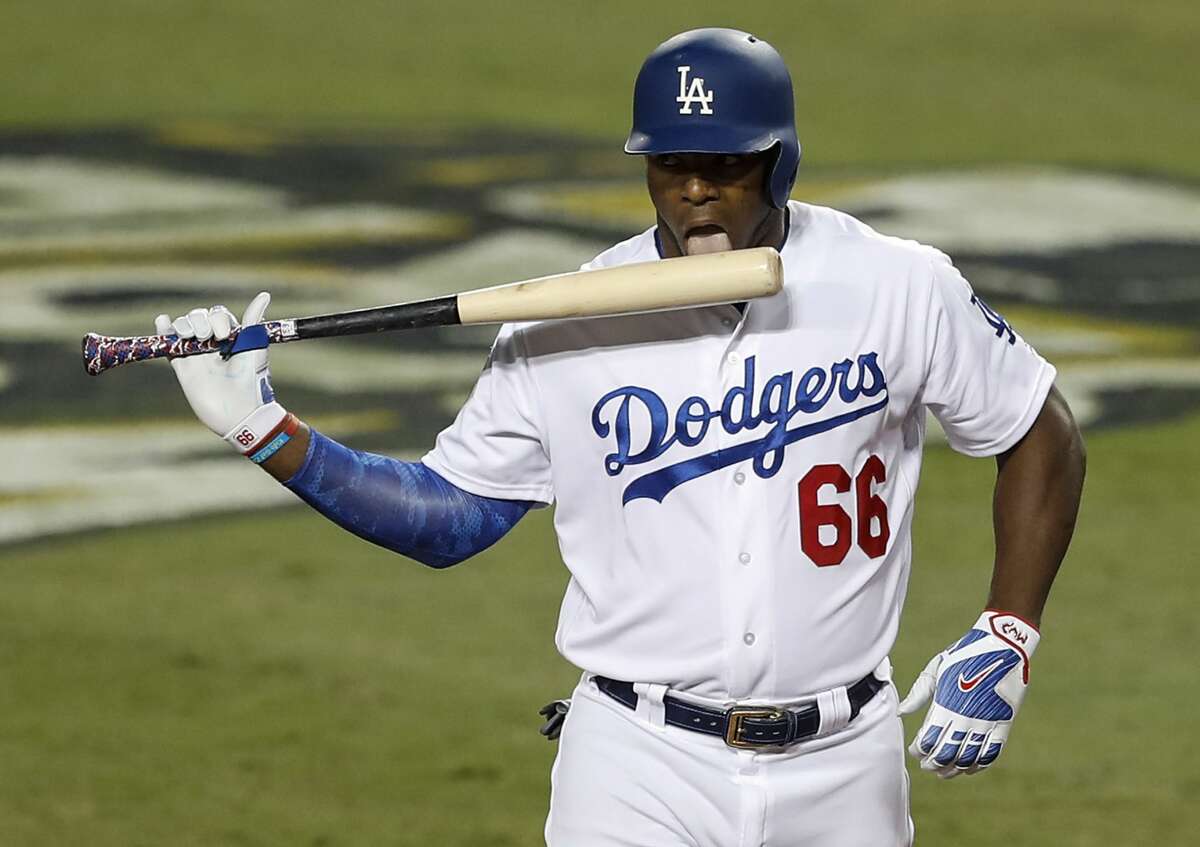 Los Angeles Dodgers right fielder Yasiel Puig licks his bat after taking a strike against Houston Astros starting pitcher Justin Verlander during the fifth inning of Game 2 of the World Series at Dodger Stadium on Wednesday, Oct. 25, 2017, in Los Angeles.