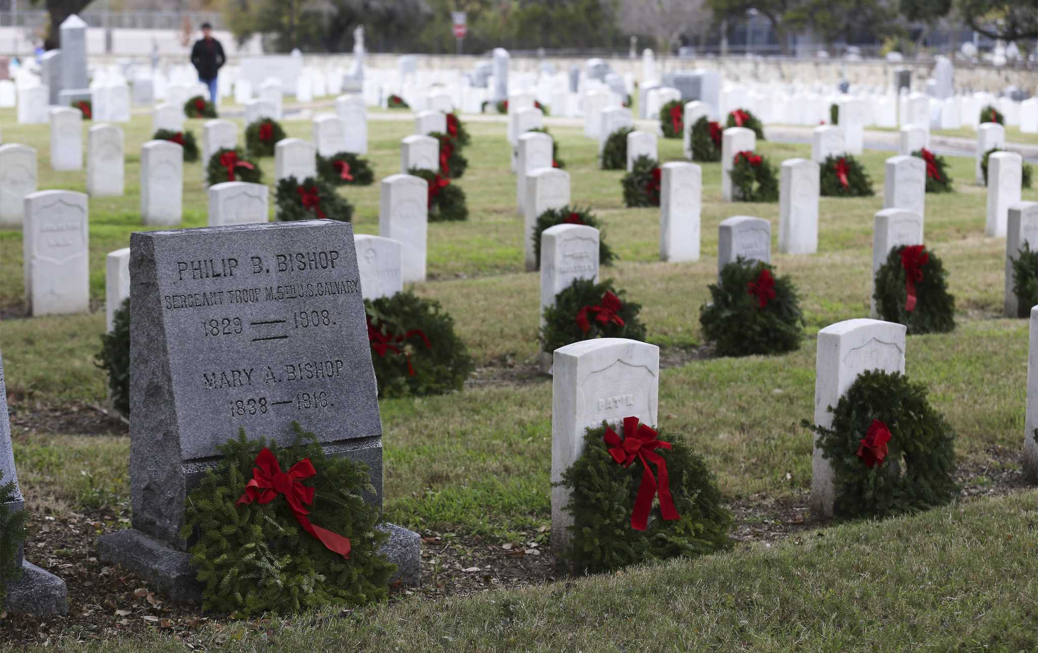 Volunteers gathered at two national cemeteries in San Antonio to lay ...