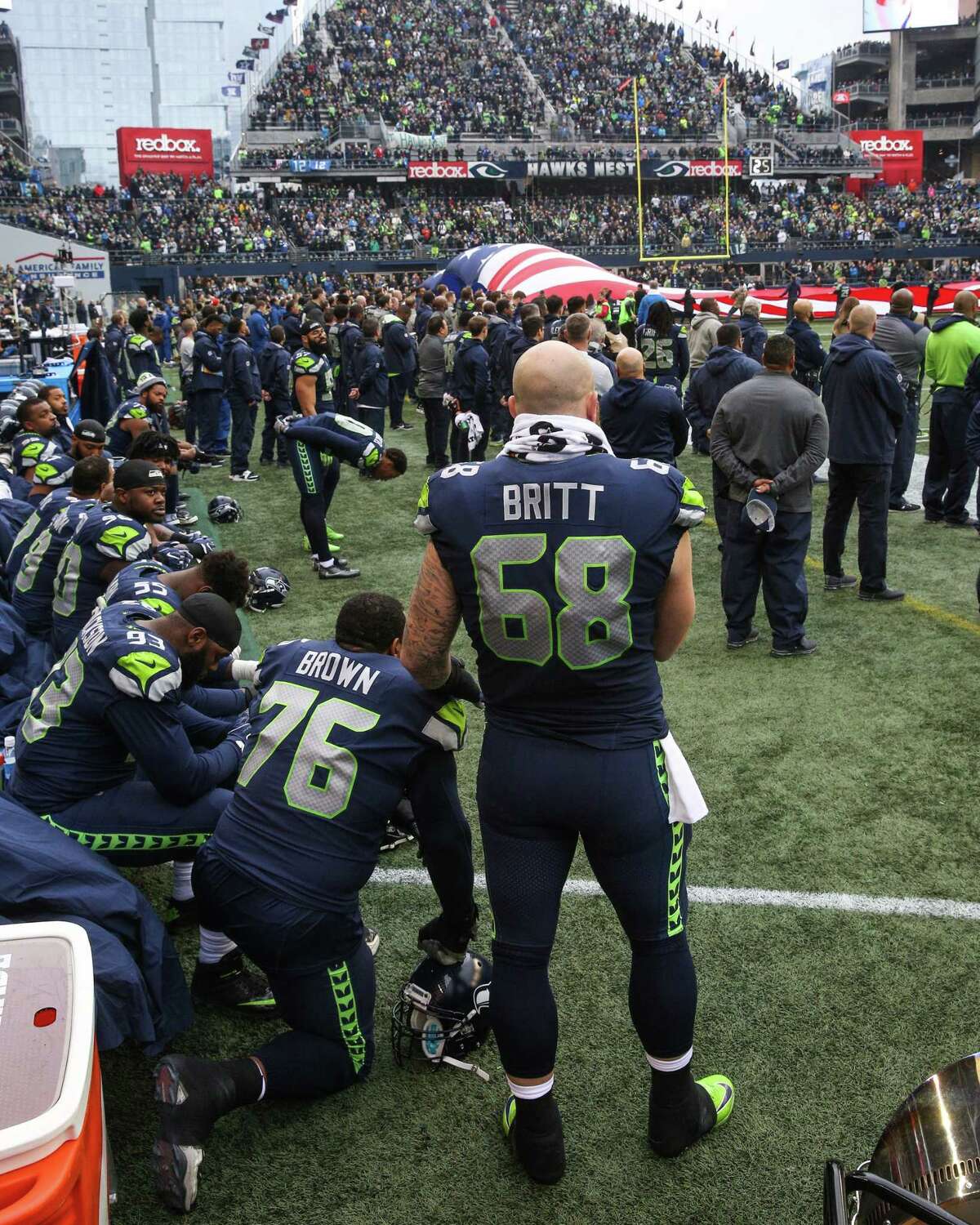 Falcons stand during both anthems; Seahawks protest