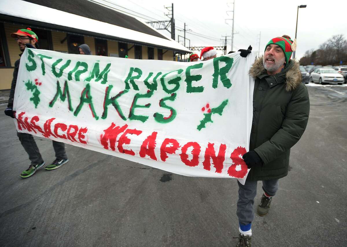 Jake Tolan, left, and Tim Murphy, march to gun maker Sturm Ruger's headquarters in Fairfield.