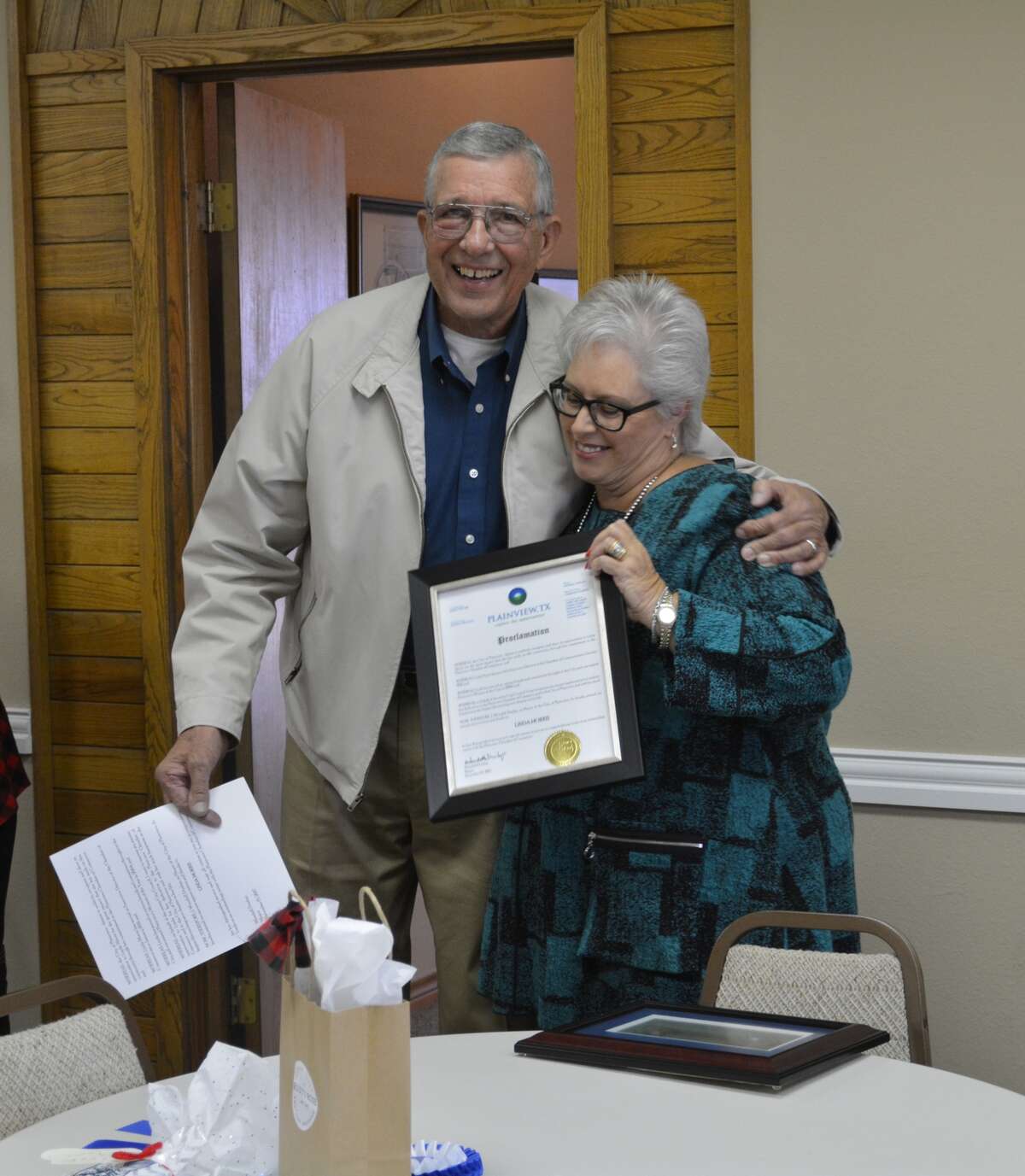 Plainview Mayor Wendell Dunlap presents Plainview Chamber Director Linda Morris with a proclamation honoring her for her years of service to the chamber during an open house event Friday. Morris is retiring as chamber director after nearly seven years at the helm of the organization.