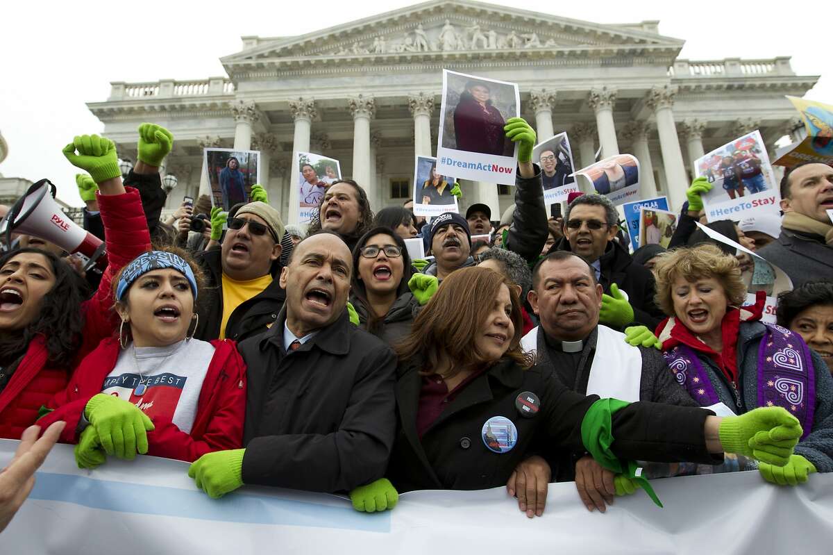 In this De. 6, 2017 photo, Rep. Luis Gutierrez D-Ill., third from left, along with other demonstrators protest outside of the U.S. Capitol in support of the Deferred Action for Childhood Arrivals (DACA), and Temporary Protected Status (TPS), programs, during an rally on Capitol Hill in Washington. House and Senate Democrats stand divided over whether to fight now or later about the fate of some 800,000 young immigrants who came to the U.S. illegally as children. ( AP Photo/Jose Luis Magana)