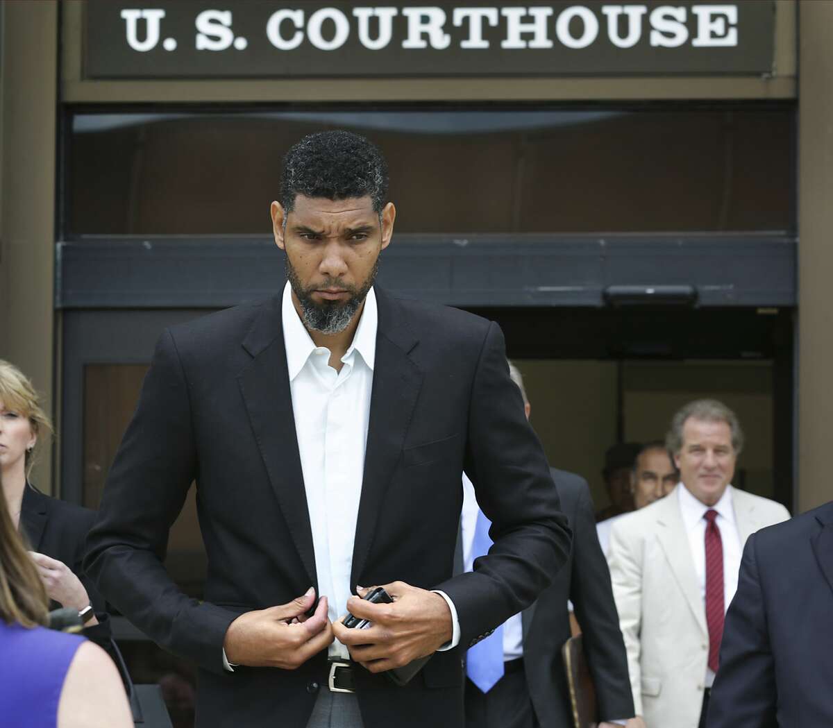 Retired Spurs player Tim Duncan, left, leaves the John H. Wood Jr. Federal Courthouse with his lawyers after the sentencing of his former financial advisor Charles Banks, on Wednesday, June 28, 2017.