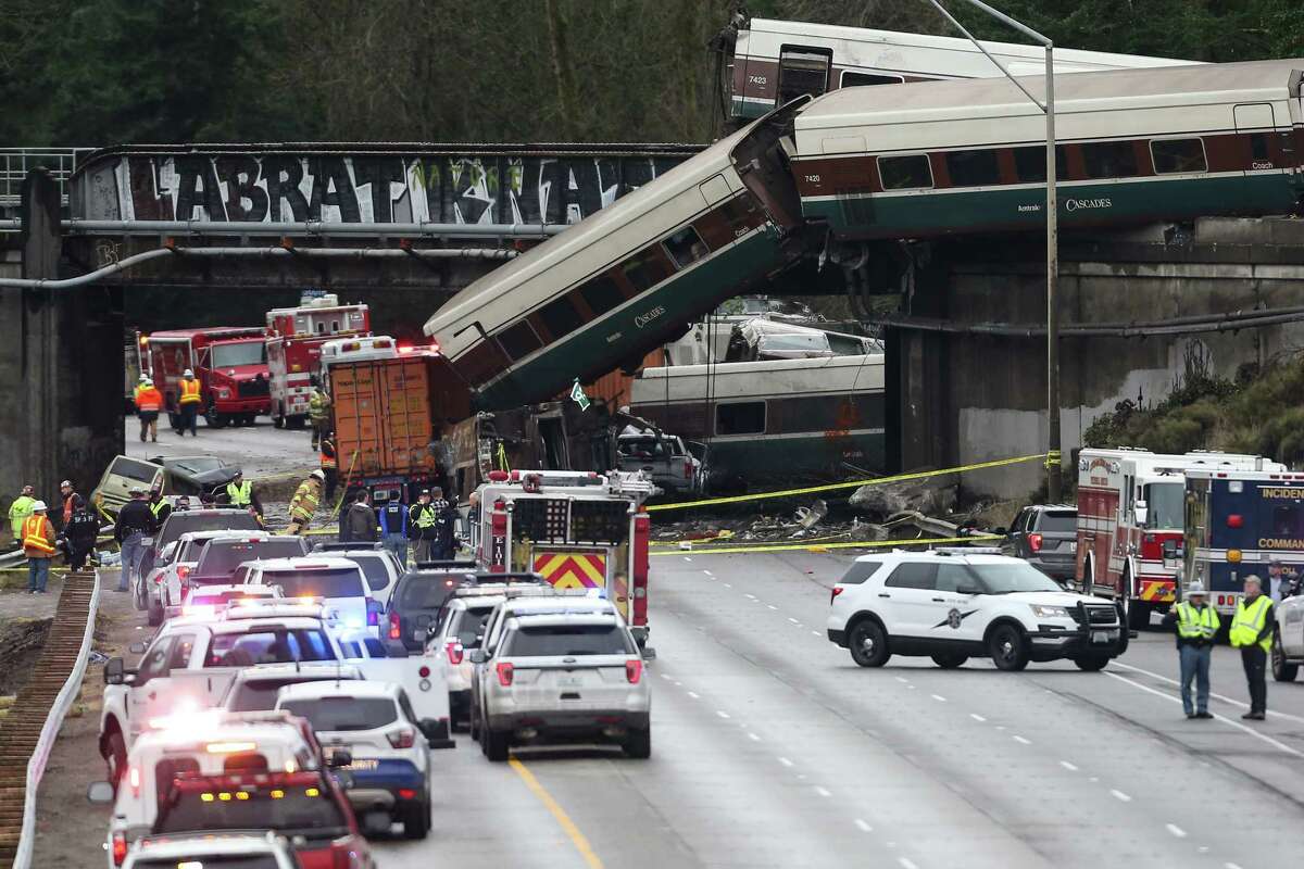 First responders work and assess the derailed Amtrak crash site in DuPont, Wash Monday, Dec. 18, 2017.