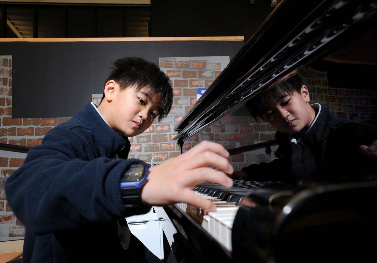 Whitby School 5th grade student Peter Liu, 10, plays the piano at the school in Greenwich, Conn., Friday, Jan. 6, 2017. Liu has been making a name for himself as a pianist, winning international awards.